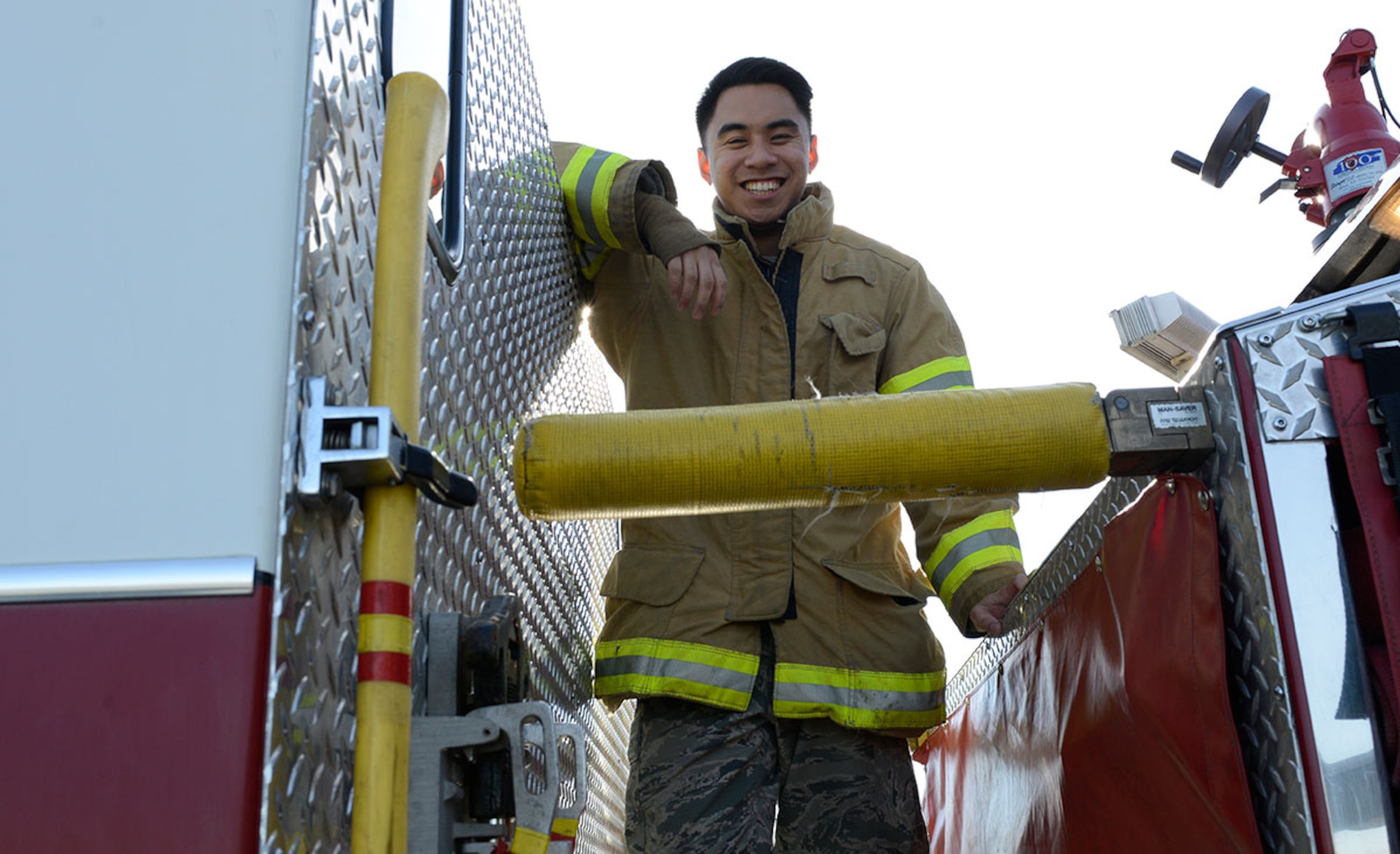 Airman 1st Class Jammie Garcia, 673d Civil Engineer Squadron firefighter, stands on a fire truck on Joint Base Elmendorf-Richardson, Alaska, Oct. 1, 2015. Firefighters learn to build a family relationship with one another when they work 24-hour shifts every other day. (U.S. Air Force photo/Airman Valerie Monroy)