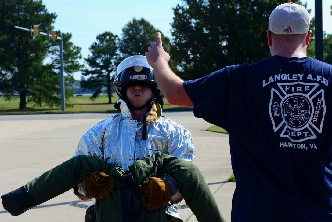 U. S Air Force Airman 1st Class Austin Goins, 633rd Medical Operations Squadron medical technician, performs a dummy carry during the Firefighter Challenge at Langley Air Force Base, Va., Oct. 9, 2015. This was the first year that Airmen outside of the fire department were able to compete in the challenge. (U.S. Air Force photo by Airman 1st Class Derek Seifert/ Released)