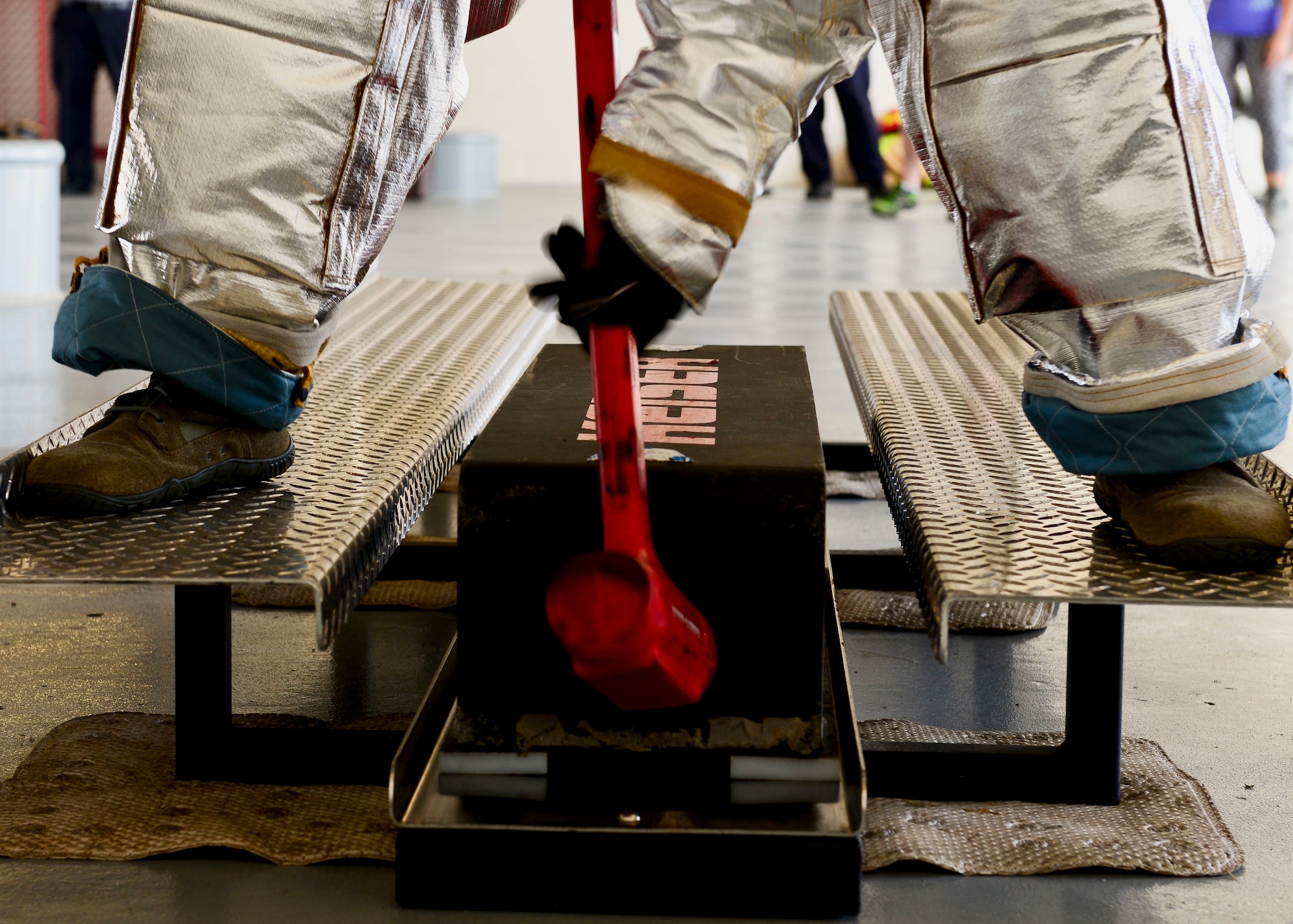 A U.S. Air Force Airman hits a block of steel with a hammer during the Firefighter Challenge at Langley Air Force Base, Va., Oct. 9, 2015. Airmen wielded a 10-pound hammer to move the 160-pound sled before continuing onto the next event. (U.S. Air Force photo by Airman 1st Class Derek Seifert/ Released) 