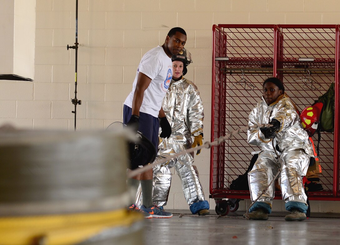 U.S. Air Force Airman 1st Class Rhanesha Radford, 633rd Medical Operations Squadron medical technician, pulls weight tied to a rope during the Firefighter Challenge at Langley Air Force Base, Va., Oct. 9, 2015. The challenge consisted of events that tested the Airmen’s physical strength and stamina that firefighters use when responding to emergencies. (U.S. Air Force photo by Airman 1st Class Derek Seifert/ Released)