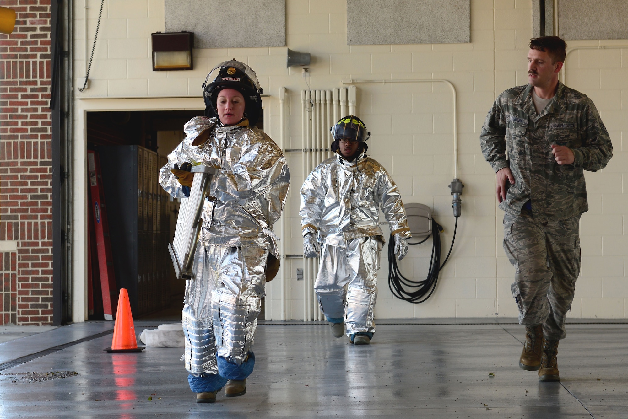 U.S. Air Force Airman 1st Class Bobbi Doughtie, 633rd Medical Operations Squadron medical technician, carries a ladder during the Firefighter Challenge at Langley Air Force Base, Va., Oct. 9, 2015. Teams of four Airmen competed for the best time during the 10-event challenge. (U.S. Air Force photo by Airman 1st Class Derek Seifert/ Released)