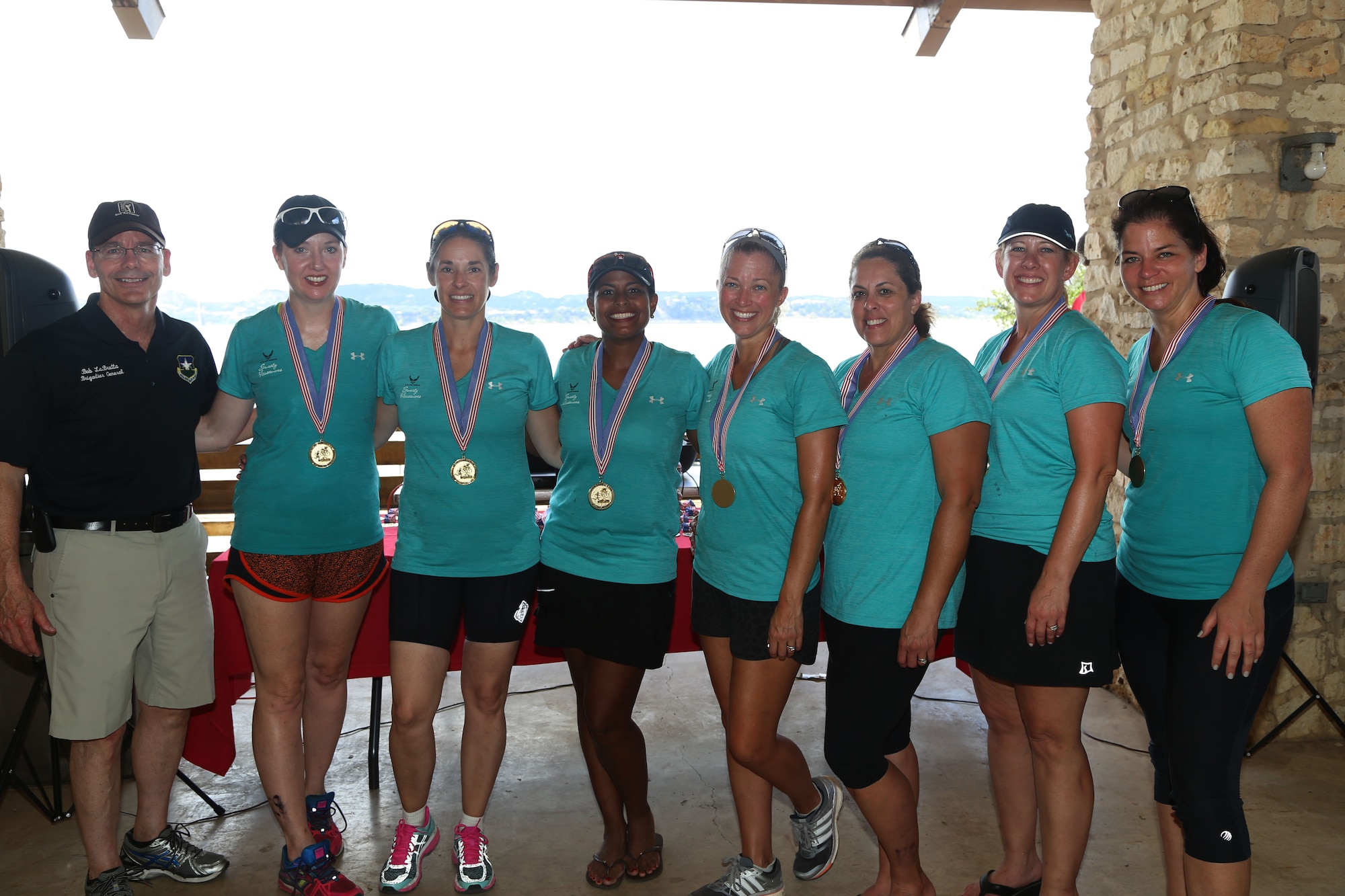 Brig. Gen. Robert LaBrutta, 502nd Air Base Wing and Joint Base San Antonio-Randolph, Texas commander, poses for photo with the Rambler 120 all-female relay team winners: Annie Vandenbussche, Cindy Fischbach, Amy Clark, Tiff Fatur, Dera Lindsey, Carri Walters and Charlotte Kelly at Joint Base San Antonio-Randolph Recreation Park at Canyon Lake Sept. 19, 2015. The Rambler 120 features four and eight-person teams competing in events to include a 22-mile bike race, 6-mile run, 2-mile raft race and a mystery event. (U.S. Air Force photo/ Johnny Saldivar)