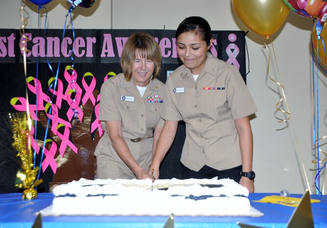 Navy Capt. Jane French, Naval Health Clinic Charleston senior nurse executive (Left) and Hospitalman Recruit Brandy Sandova, general hospital corpsman, cut the cake during NHCC's celebration of the Navy's 240th birthday Oct. 13 at the clinic. (Navy photo/ Kris Patterson)