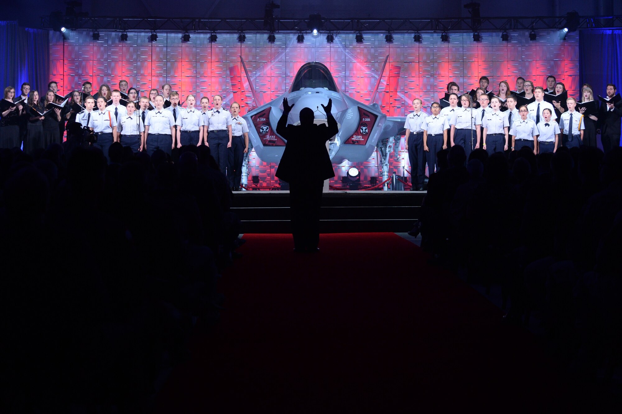 The Utah Military Academy Choir and Weber State University Chamber Choir perform during an F-35A Lightning II aircraft unveiling ceremony at Hill Air Force Base, Utah, Oct. 14, 2015. The unveiling commemorated the arrival of the Lightning II to the base. The 388th and 419th Fighter Wings at Hill were selected as the first Air Force units to fly combat-coded F-35s. (U.S. Air Force photo by R. Nial Bradshaw/Released)