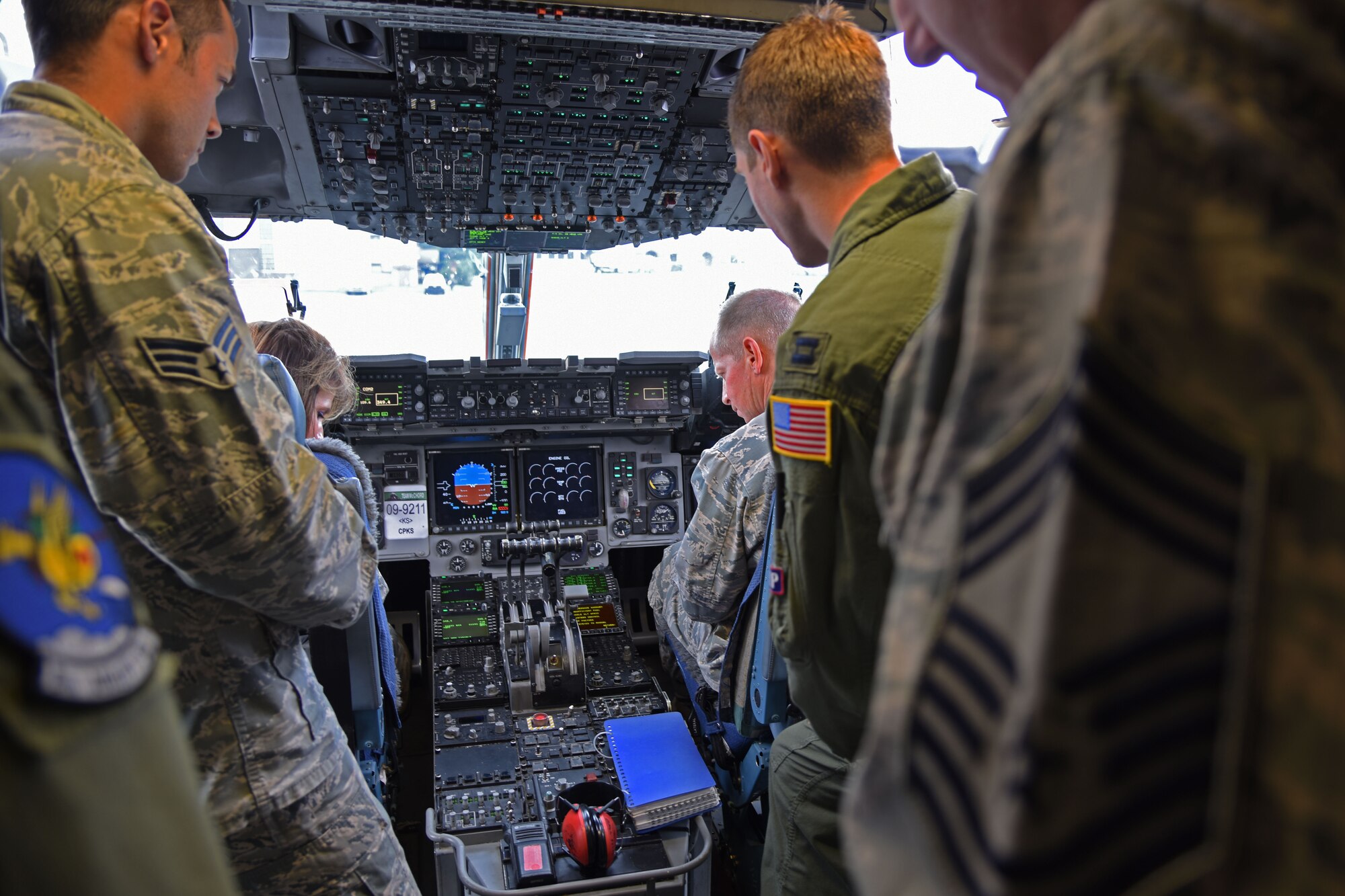 Pilots and maintenance personnel from the 62nd Airlift Wing explain different components of the flight deck of a C-17 Globemaster III aircraft to Air Mobility Command staff judge advocate and senior paralegals during their visit to McChord Field, Wash., Oct. 8, 2015. The AMC staff judge advocate and senior paralegals’ visit was motivated by the need to understand the environment, people, and issues at each AMC installation to deliver the best possible legal advice to AMC, to develop and sustain the right levels of legal capacity and capability across AMC, and to learn about the individual strengths and professional goals of all AMC judge advocates and paralegals. (U.S. Air Force photo/Staff Sgt. Katie Jackson)