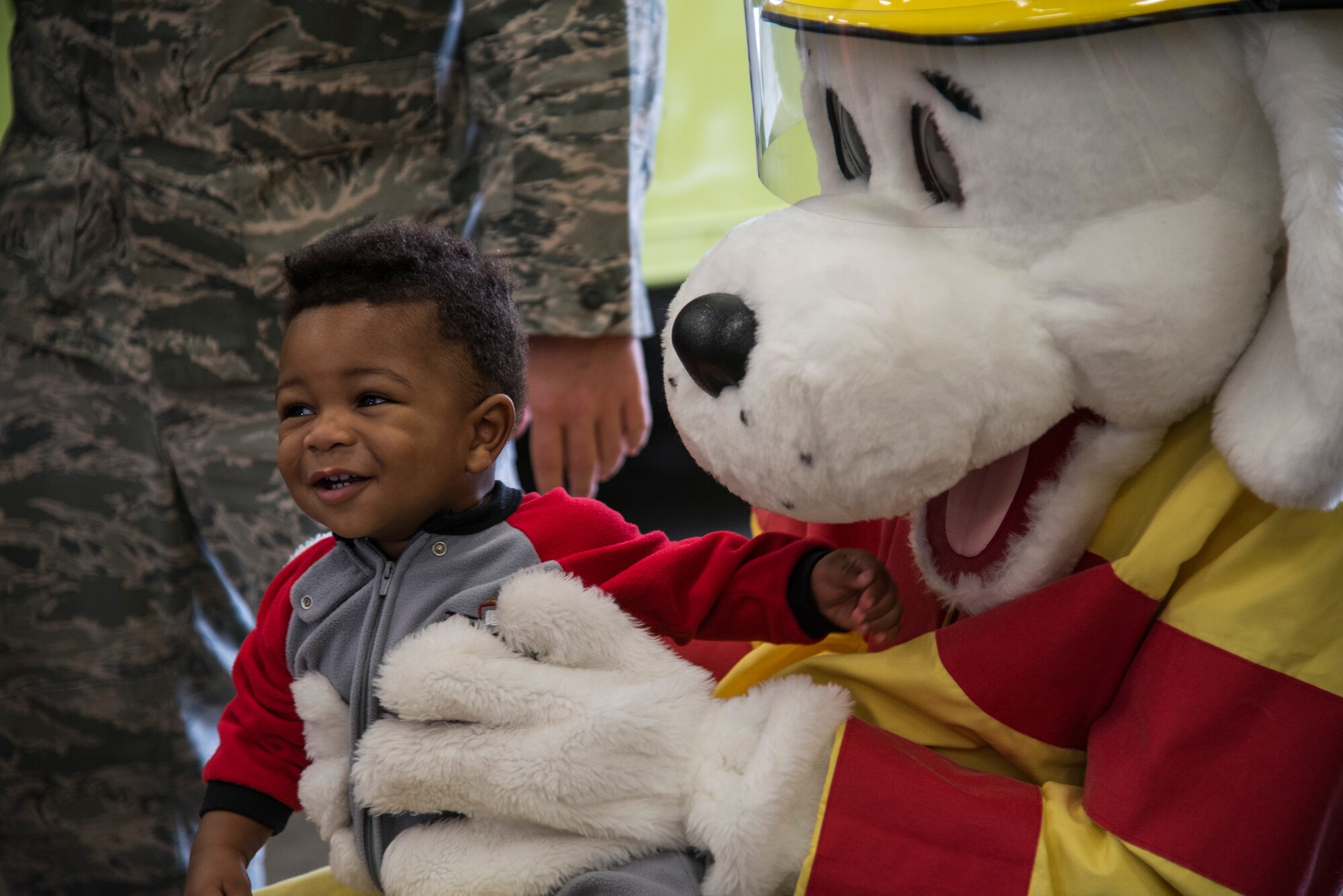 Staff Sgt. Daniel Norris answers questions about fire safety during fire prevention week, October 5, 2015, at the Patriots Landing Fire Station. Fire prevention week is held to help raise awareness of fire safety to children and their families. (U.S. Air Force photo by Airman Gwendalyn Smith)