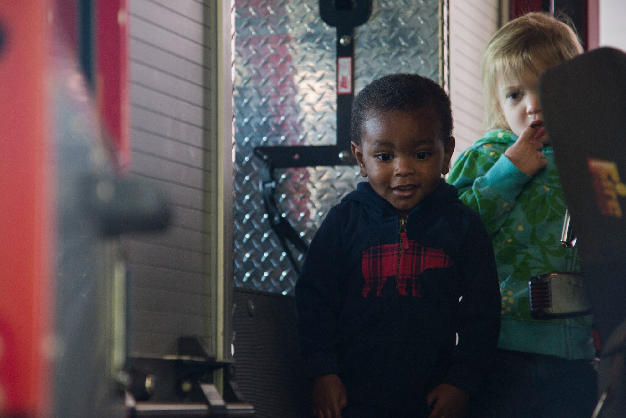 Children walk through a fire truck during fire prevention week, October 5, 2015, at the Patriots Landing Fire Station. Fire prevention week is held to help raise awareness of fire safety to children and their families. (U.S. Air Force photo by Airman Gwendalyn Smith)