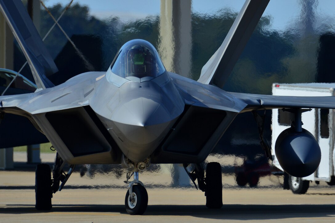 A U.S. Air Force Airmen brings chalks out to an F-22 Raptor at Langley Air Force Base, Va., Oct. 9, 2015. The pilots, who are assigned to the 1st and 192nd Fighter Wings, were returning from a deployment to the Middle East during which they supported United States Central Command in providing security to the region. (U.S. Air Force photo by Staff Sgt. Natasha Stannard/Released)