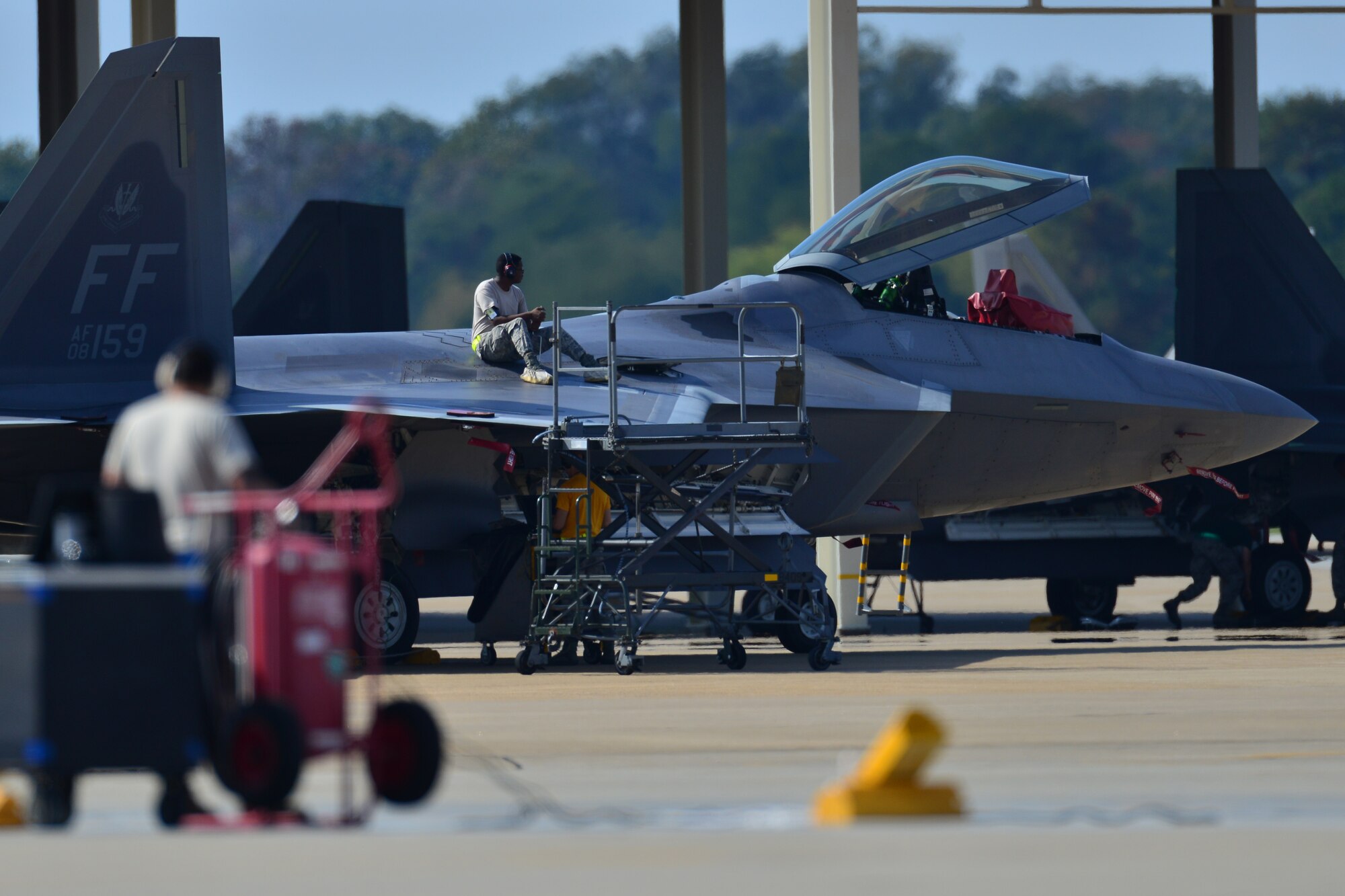 U.S. Air Force Airmen assigned to Langley Air Force Base await the return of 1st and 192nd Fighter Wing members redeploying at Langley Air Force Base, Va., Oct. 9, 2015. During their deployment supporting Operation Inherent Resolve, the Airmen teamed up with U.S. and coalition forces to conduct targeted air strikes in Iraq and Syria as a part of the comprehensive strategy to degrade the self-proclaimed Islamic State of Iraq and the Levant. (U.S. Air Force photo by Staff Sgt. Natasha Stannard/Released)