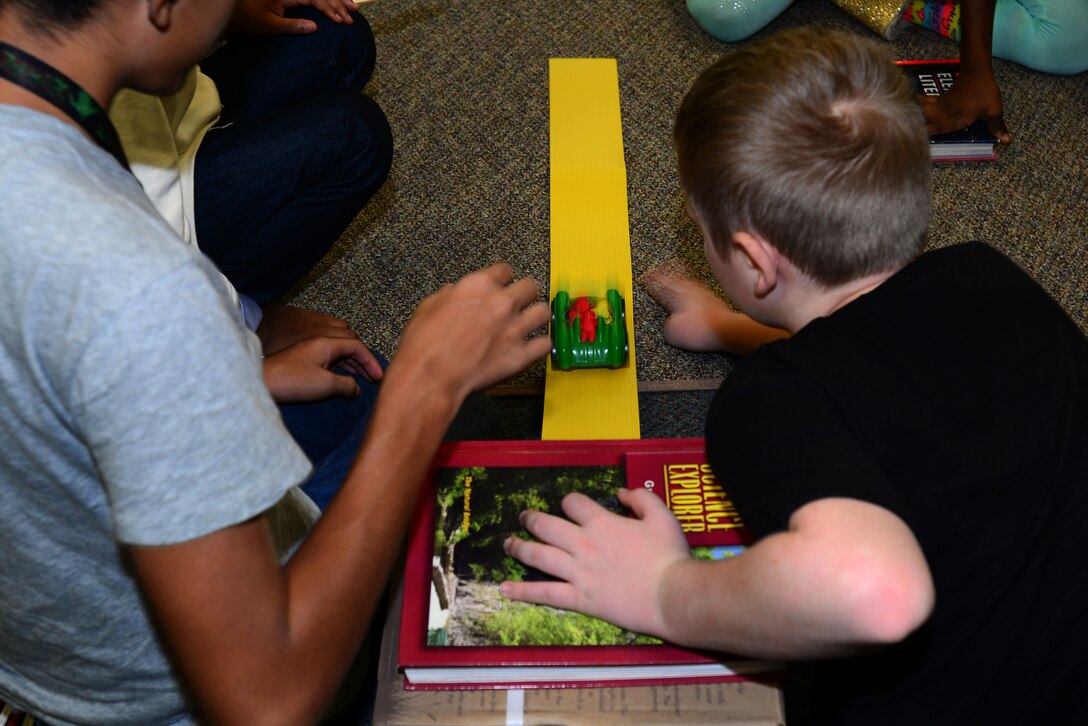 Children from the Joint Base Langley-Eustis Youth Program, participate in the 4-H National Youth Science Day at Fort Eustis, Va., Oct. 7, 2015. Through the experiment, Motion Commotion, the students gained knowledge on physics, speed and safety. (U.S. Air Force photo by Senior Airman Kimberly Nagle/Released)
