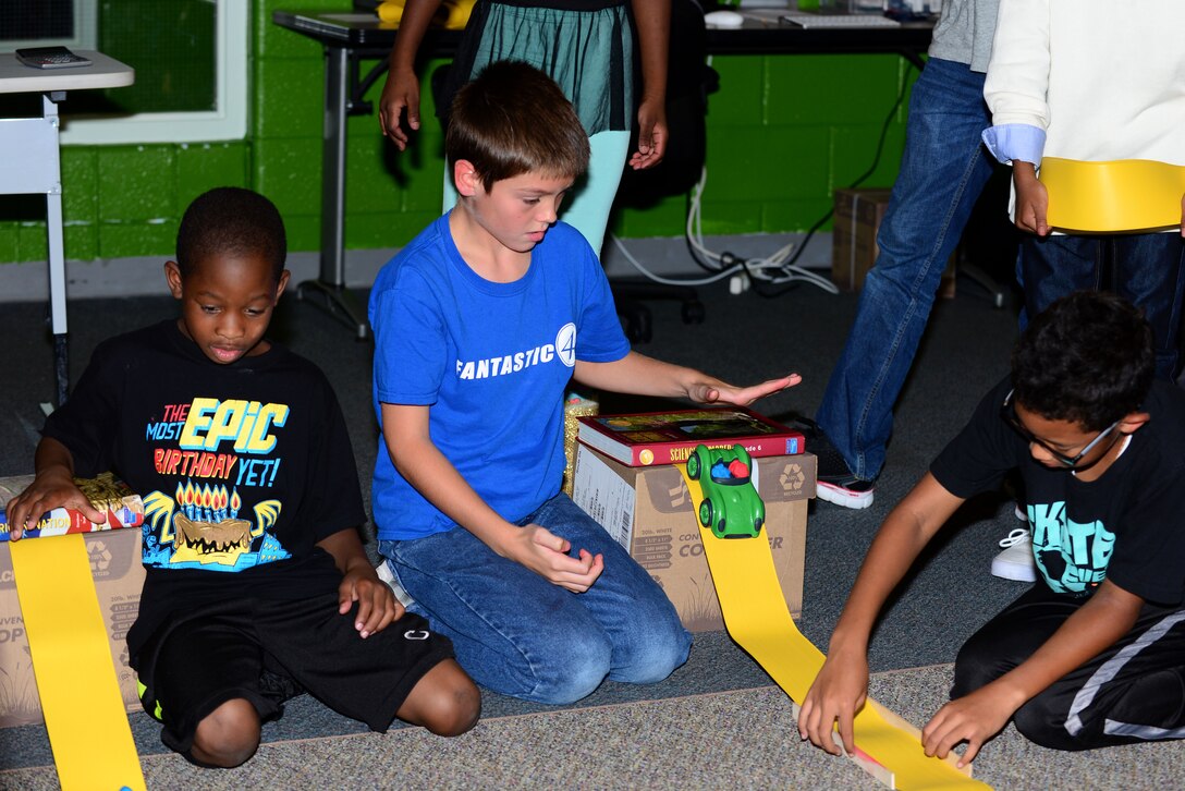 Children from the Joint Base Langley-Eustis Youth Program participate in the 4-H National Youth Science Day at Fort Eustis, Va., Oct. 7, 2015. During the science day, students were able to explore the science of motion. (U.S. Air Force photo by Senior Airman Kimberly Nagle/Released)