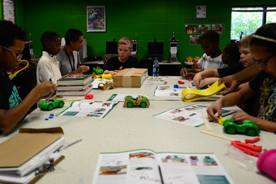 Children from the Joint Base Langley-Eustis Youth Program, prepare projects for the 4-H National Youth Science Day at Fort Eustis, Va., Oct. 7, 2015. The project is geared toward middle and high school-aged students as a way to provide real-world investigations on reaction time and safety making connections regarding the dangers of distracted driving. (U.S. Air Force photo by Senior Airman Kimberly Nagle/Released)
