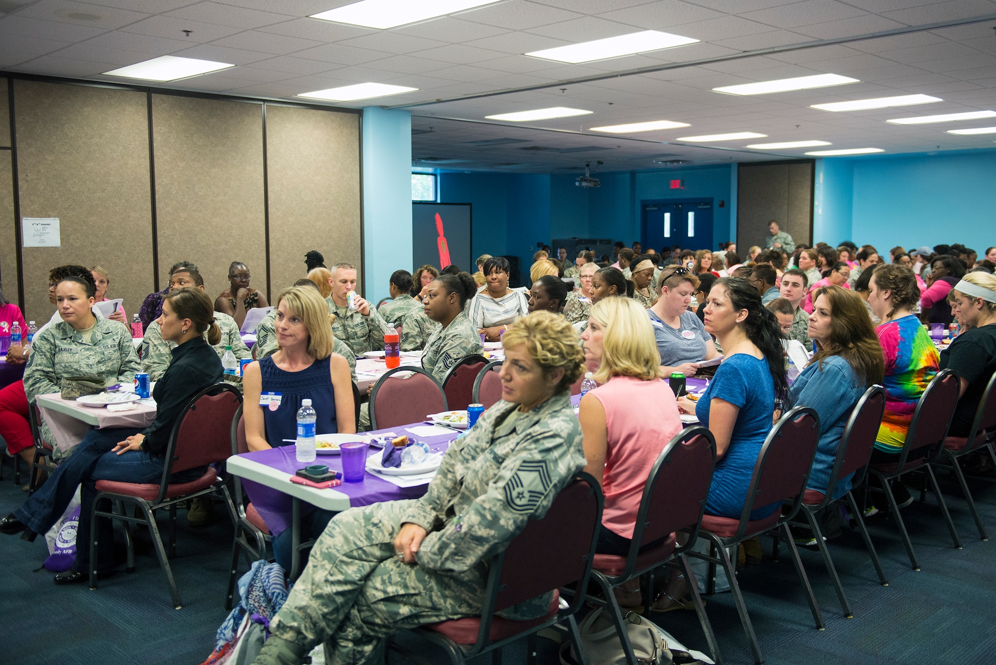 Airmen and local community members participate in a Breast Cancer and Domestic Violence Awareness luncheon, Oct. 8, 2015, at Moody Air Force Base, Ga. The event was designed to raise awareness about breast cancer and domestic violence and how to seek help if affected by them. (U.S. Air Force photo by Airman 1st Class Greg Nash/Released)