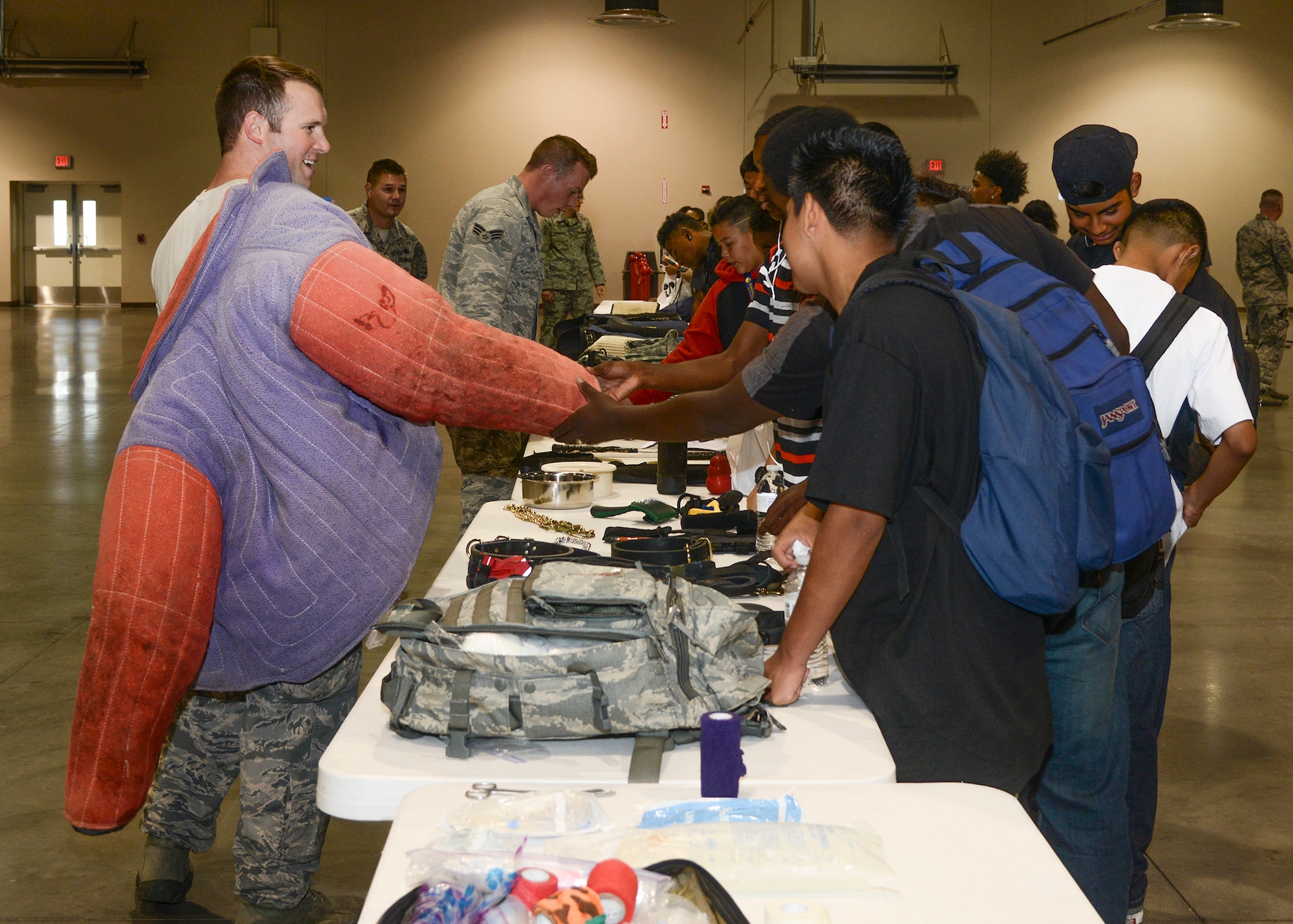 The 412th Security Forces Squadron set up a military working dog demonstration. After the first demonstration, Senior Airman Noah Hyatt, showed the bite suit he wore to students to show how it protects them during training and demonstrations. (U.S. Air Force photo by Rebecca Amber)