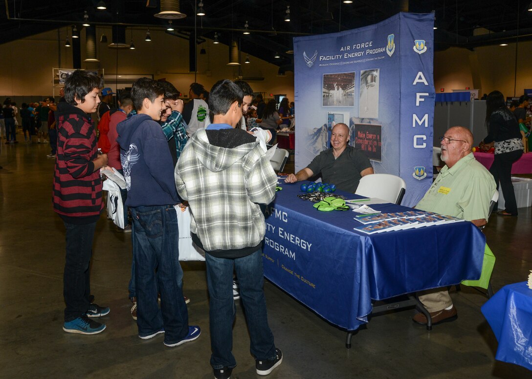 Richard Morris (left) and Jack Frazier (right), 412th Civil Engineer Group Energy team, set up a booth to introduce students to the Air Force Facility Energy Program at the 24th Annual Salute to Youth event at the Antelope Valley Fairgrounds in Lancaster, California. (U.S. Air Force photo by Rebecca Amber)