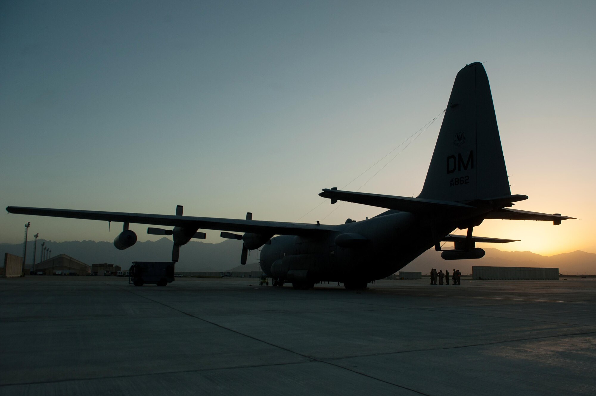 U.S. Airmen assigned to the 41st Expeditionary Electronic Combat Squadron talk during an EC-130H Compass Call aircraft final mission meeting on the flight line at Bagram Air Field, Afghanistan, Sept. 6, 2015. The Compass Call is an airborne tactical weapon system using a heavily modified version of the C-130 Hercules airframe. (U.S. Air Force photo by Tech. Sgt. Joseph Swafford/Released)