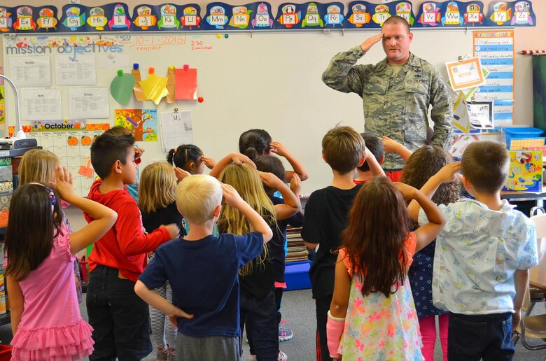 Master Sgt. Ryan Laube, 50th Contracting Squadron Base Infrastructure Flight noncommissioned officer in charge, teaches a classroom of Ellicott Elementary School students how to render a salute during a school visit Wednesday, Oct. 7, 2015, in Ellicott, Colorado. In addition to teaching the children military customs and courtesies, Laube also spoke about what it is like to be in the military and answered the students’ questions. More than 200 military children from Schriever Air Force Base attend Ellicott School District. (Courtesy photo)