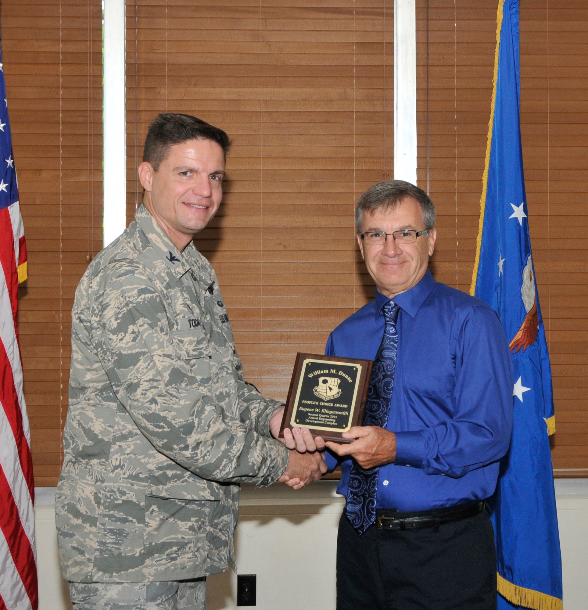 AEDC Aerospace Engineer Gene Klingensmith (right) accepts the William M. Dunne People’s Choice award from AEDC Commander Col. Rodney Todaro during the AEDC Quarterly Awards Breakfast at the Arnold Lakeside Center July 22. (Photo by Jacqueline Cowan)