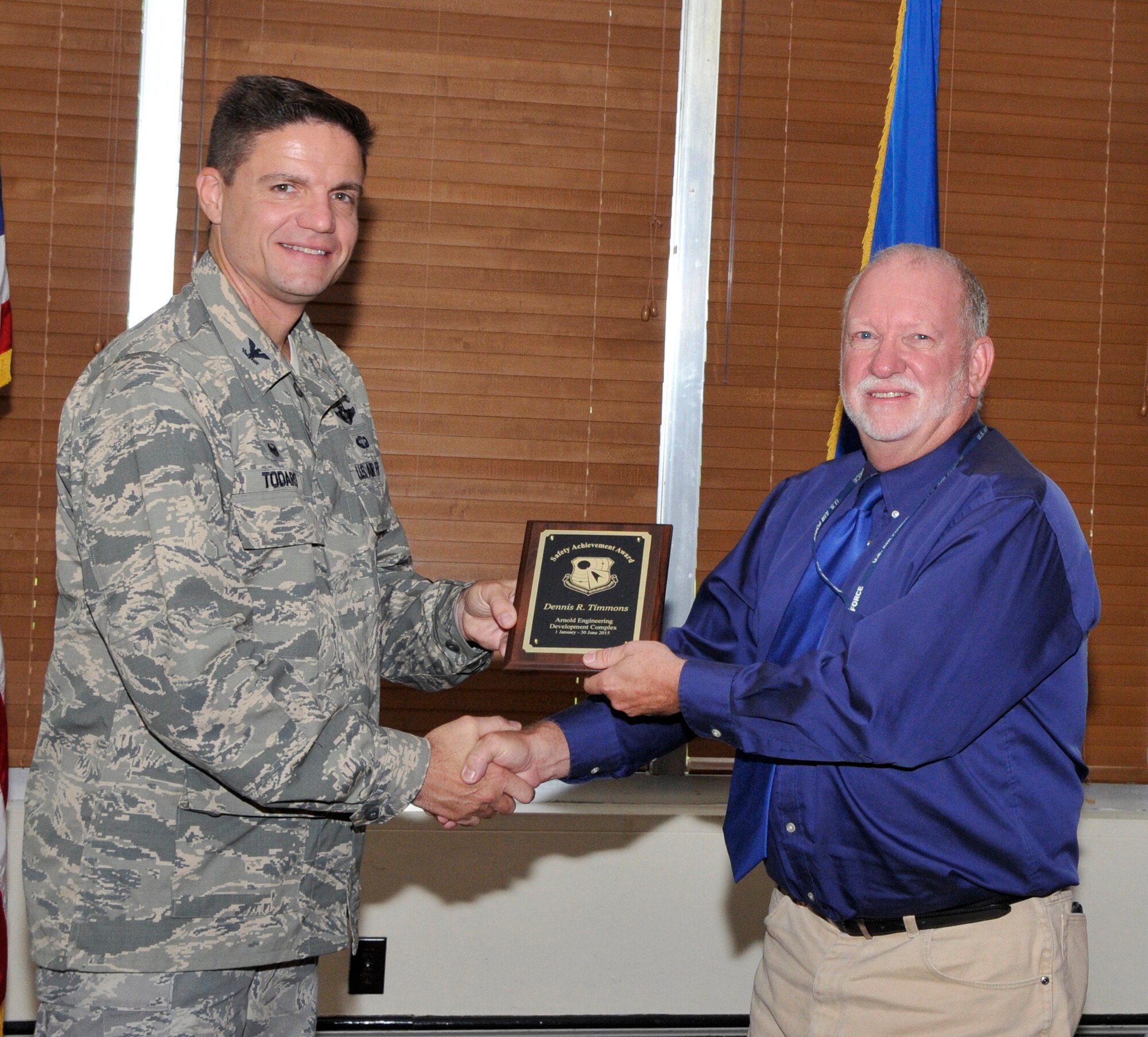 Denny Timmons (right), with the AEDC Test Support Division, accepts the AEDC Safety Achievement Award from AEDC Commander Col. Rodney Todaro at the Complex quarterly award breakfast July 22. (Photo by Jacqueline Cowan)