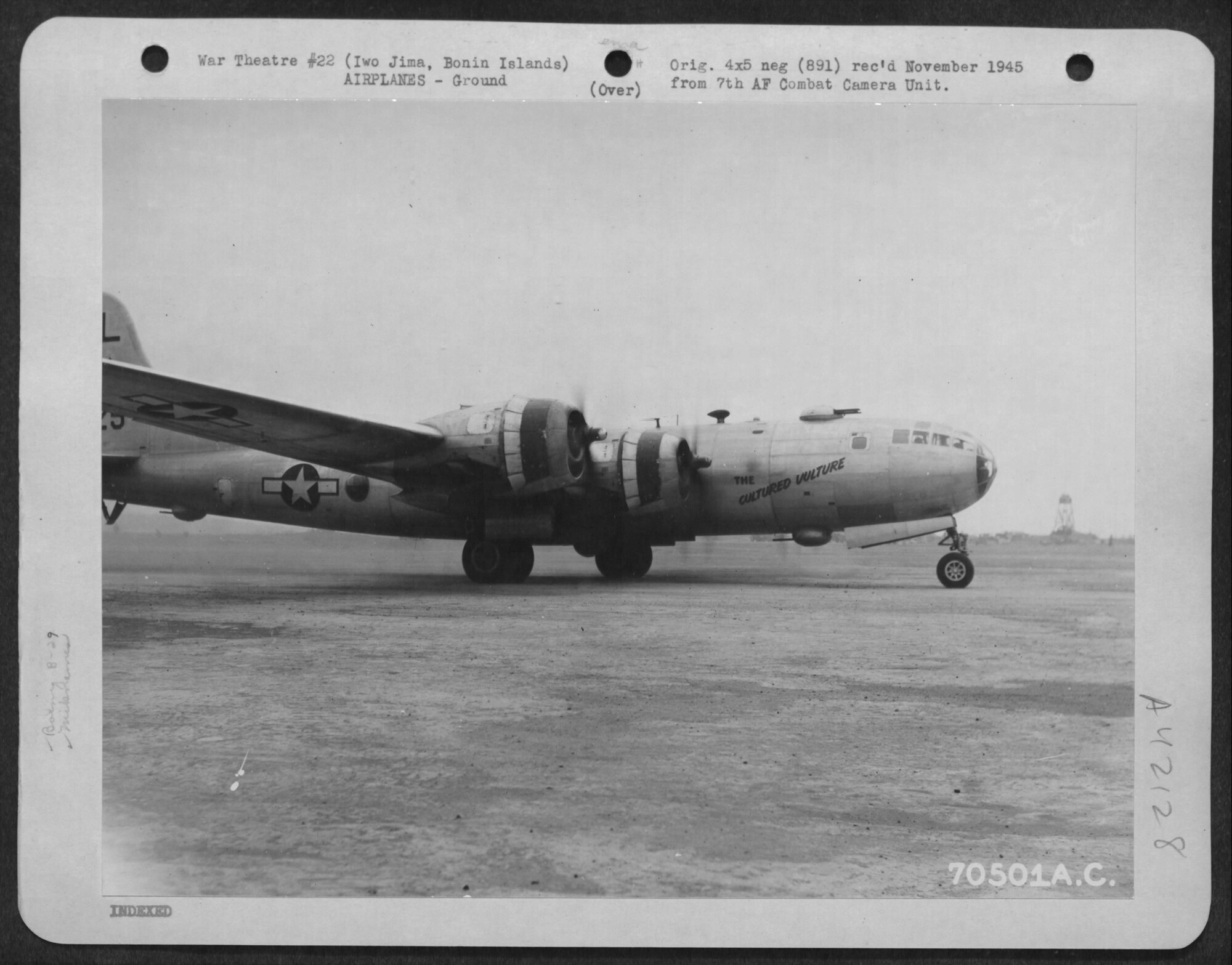 Navigator Bob Frick flew many of his 31 combat missions with Crew # 3918 aboard “The Cultured Vulture,” a B-29-55-BW Superfortress, serial number 42-24901 assigned to the 39th Bomb Squadron.  Note the early markings of the 6th Bomb Group, with the “L” on top of the tail, and the lack of the Jean Lafitte motif on the nose.  This photo was taken at Iwo Jima on 10 March 1945, after “The Cultured Vulture” stopped for fuel following a raid on Tokyo and was preparing to return to Tinian.  (US Army photograph, courtesy National Archives via Fold3)