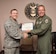 Staff Sgt. Luke Carnathan, 12th Air Force (Air Forces Southern) spectrum manager, smiles after being presented the Warfighter of the Week from Col. Robert Stonemark, 12th AF (AFSOUTH) chief of staff, on Sept. 21, 2015 at Davis-Monthan AFB, Ariz. War Fighter of the Week is an opportunity for the Airmen who represent 12th AF (AFSOUTH) to share their story. The Warfighter of the Week intuitive also aligns with the 12th AF (AFSOUTH) commander’s priority of creating a work environment where someone knows you both professionally and personally. (U.S. Air Force photo by Staff Sgt. Adam Grant/Released)
