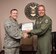 Staff Sgt. Luke Carnathan, 12th Air Force (Air Forces Southern) spectrum manager, smiles after being presented the Warfighter of the Week from Col. Robert Stonemark, 12th AF (AFSOUTH) chief of staff, on Sept. 21, 2015 at Davis-Monthan AFB, Ariz. War Fighter of the Week is an opportunity for the Airmen who represent 12th AF (AFSOUTH) to share their story. The Warfighter of the Week intuitive also aligns with the 12th AF (AFSOUTH) commander’s priority of creating a work environment where someone knows you both professionally and personally. (U.S. Air Force photo by Staff Sgt. Adam Grant/Released)
