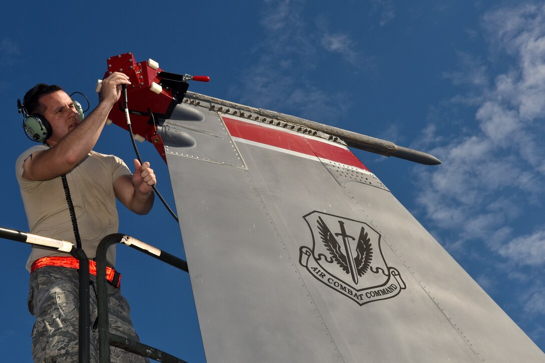Senior Airman Christopher Lemons, 4th Aircraft Maintenance Squadron avionics technician, attaches an antenna coupler to an F-15E Strike Eagle, Oct. 13, 2015, at Seymour Johnson Air Force Base, North Carolina. The coupler, in conjunction with the Joint Service Electronic Combat Systems Tester, is used to routinely test the effectiveness of the aircraft’s threat detection systems. (U.S. Air Force photo/Senior Airman Aaron J. Jenne)
