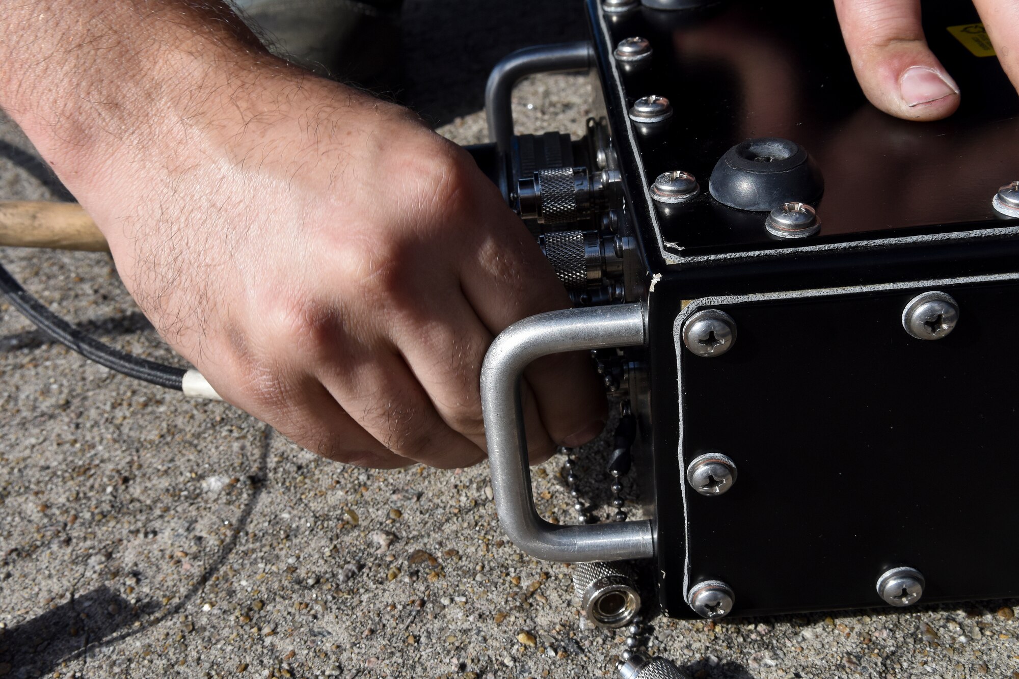 Staff Sgt. Andrew Menkes, 4th Aircraft Maintenance Squadron avionics technician, attaches cables to a component of the Joint Service Electronic Combat Systems Tester on Oct. 13, 2015, at Seymour Johnson Air Force Base, North Carolina. Avionics technicians use the JSECST equipment to test the effectiveness of the ALR-56C Radar Warning Receiver System. (U.S. Air Force photo/Senior Airman Aaron J. Jenne)