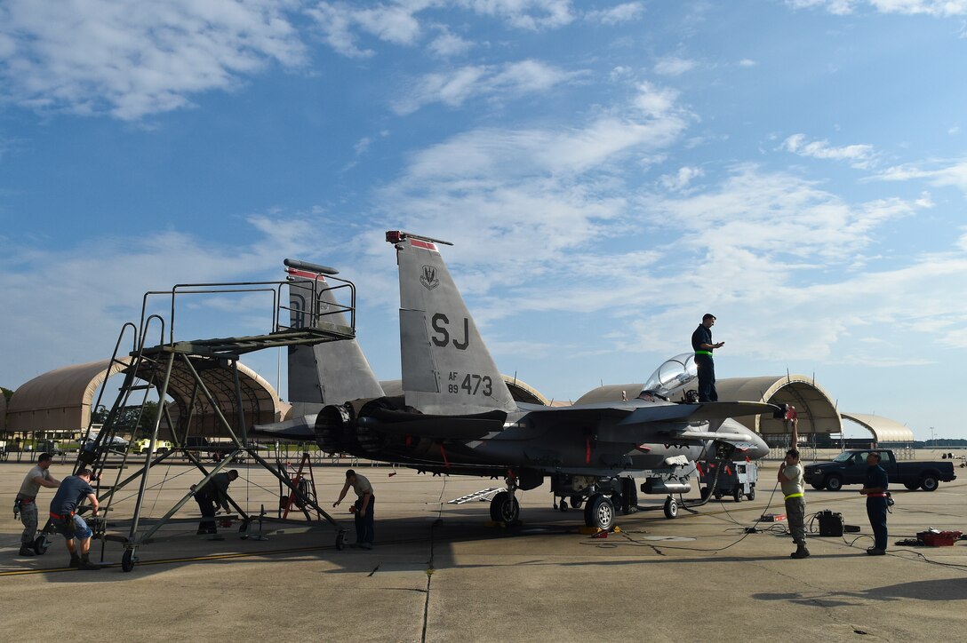 Avionics Airmen assigned to the 4th and 414th Aircraft Maintenance Squadrons prepare to test the threat detection systems on an F-15E Strike Eagle Oct. 13, 2015, at Seymour Johnson Air Force Base, North Carolina. The ALR-56C Radar Warning Receiver System requires testing every 180 days to ensure pilot safety. (U.S. Air Force photo/Senior Airman Aaron J. Jenne)