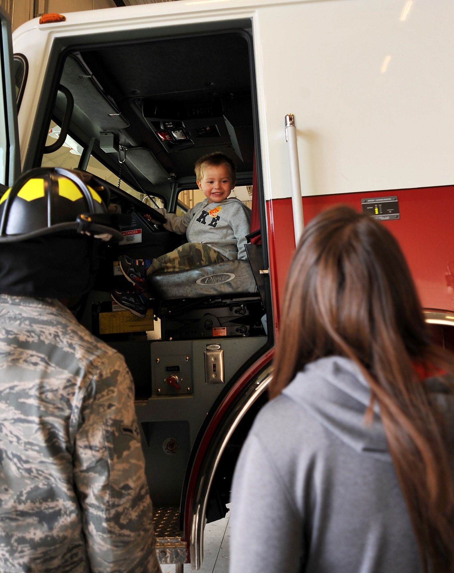 Isaac Newborg, 2, sits at the wheel of a firetruck during the Grand Forks Air Force Base Fire Department open house and pancake breakfast on Grand Forks AFB, North Dakota, Oct. 10, 2015. The open house ended Fire Prevention Week which lasted Oct. 5-9. (U.S. Air Force photo/Airman 1st Class Bonnie Grantham/Released)