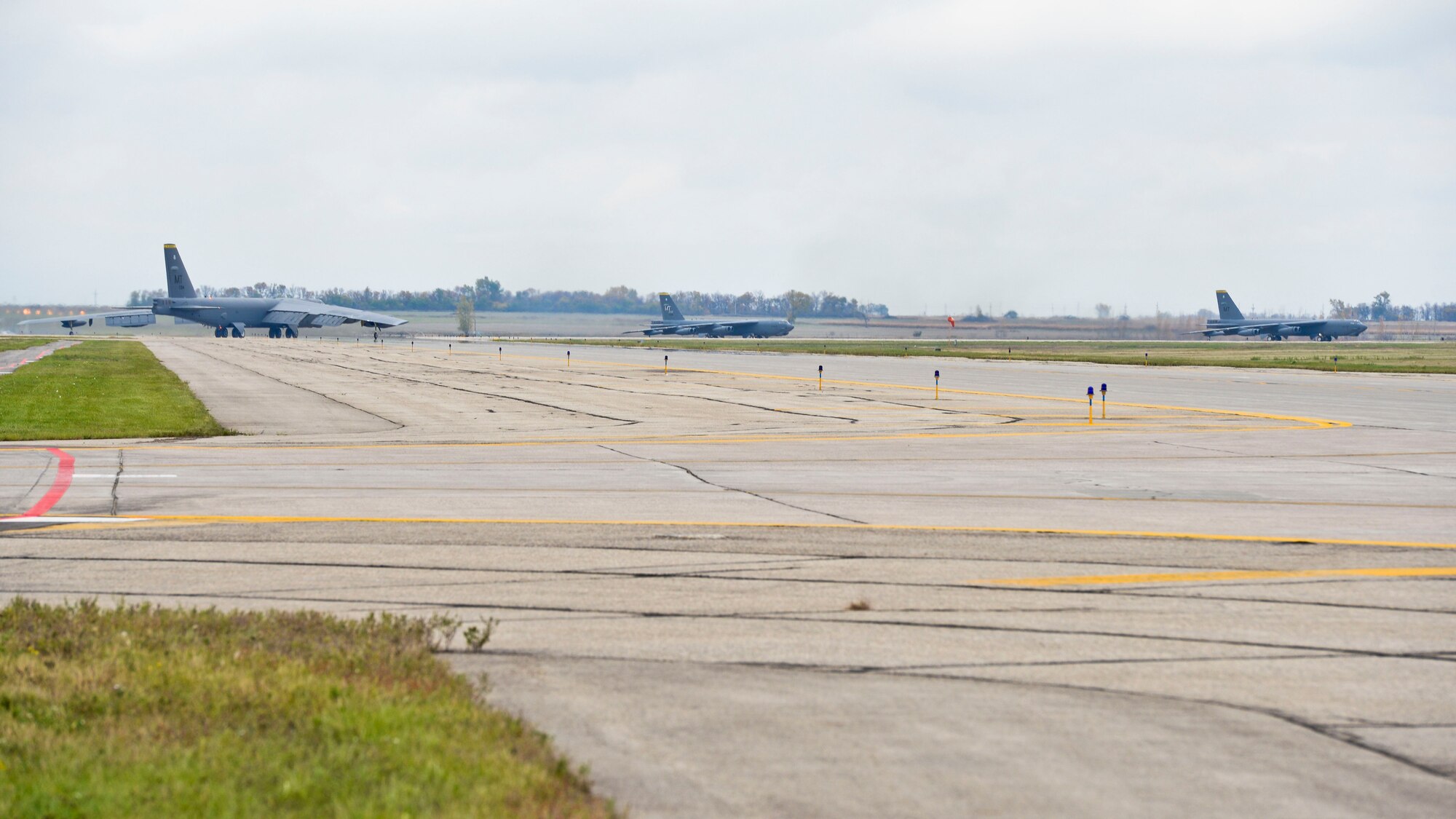 Three B-52H Stratofortresses taxi into the runway during a fly-off at Minot Air Force Base, N.D., Oct. 8, 2015.  The flyoff was a rapid launch exercise to test the 5th Bomb Wing’s ability to swiftly put aircraft in the air. (U.S. Air Force photo/ Airman 1st Class J. T. Armstrong)