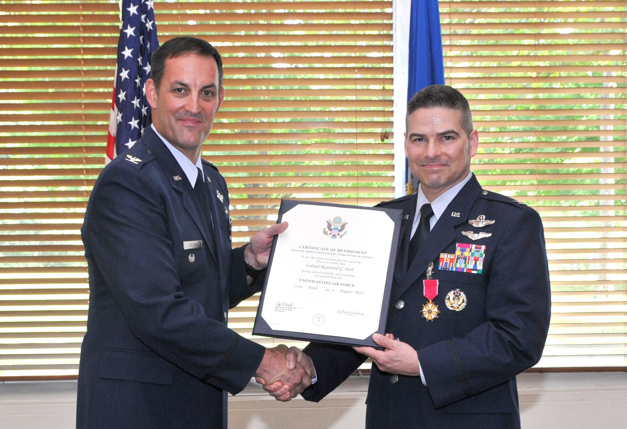 The 28th commander of AEDC, Col. Raymond Toth (right), retires from the Air Force after 26 years of service. At a retirement ceremony on June 26 at the Arnold Lakeside Center, Col. Keith Colmer, the presiding official, is shown presenting a Certificate of Retirement to Toth. (Photo by Jacqueline Cowan)