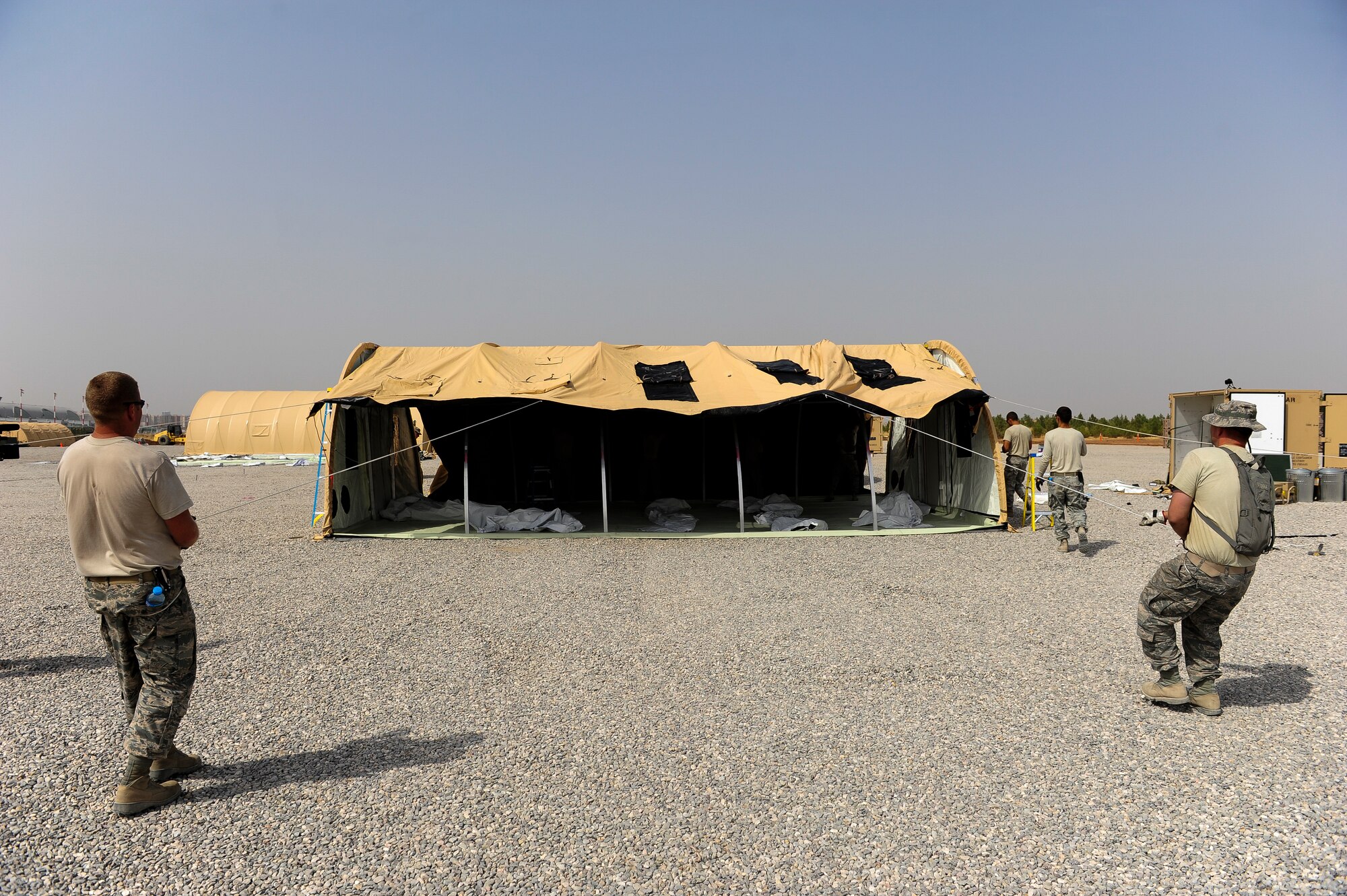 Two Airmen assigned to the 435th Construction Training Squadron, construct a shelter Sept. 15, 2015, at Diyarbakir Air Base, Turkey.  U.S. Air Forces Central Command has begun staging small detachments of aircraft and Airmen at Diyarbakir Air Base in southeast Turkey to enhance Coalition capabilities to support personnel recovery operations in Syria and Iraq. Diyarbakir Air Base is a Turkish base home to the Turkish air force's 8th Air Wing. The USAF will be guests of the Government of Turkey at DAB, and  there are no plans for a permanent U.S. presence at this location. (U.S. Air Force photo by Airman Cory W. Bush/Released)