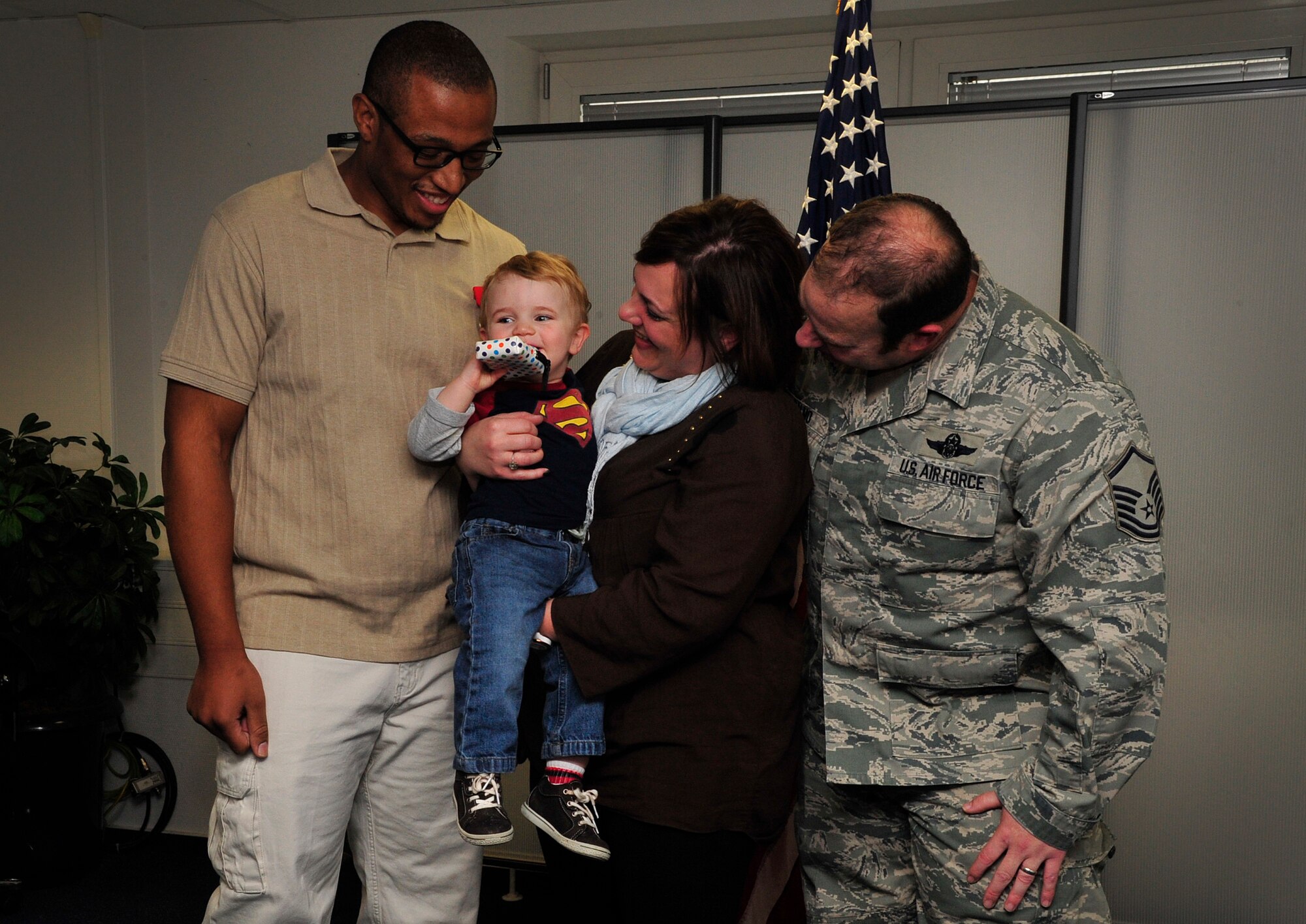 Sean Tatum, 86th Force Support Squadron caregiver, stands with the Dalmo family for photos during a Red Cross Lifesaving Award ceremony Oct. 8, 2015, at Ramstein Air Base, Germany.Tatum utilized his Red Cross health and safety skills to dislodge food from Jackson Dalmo’s throat July 1, 2015. (U.S. Air Force photo/Airman 1st Class Larissa Greatwood)