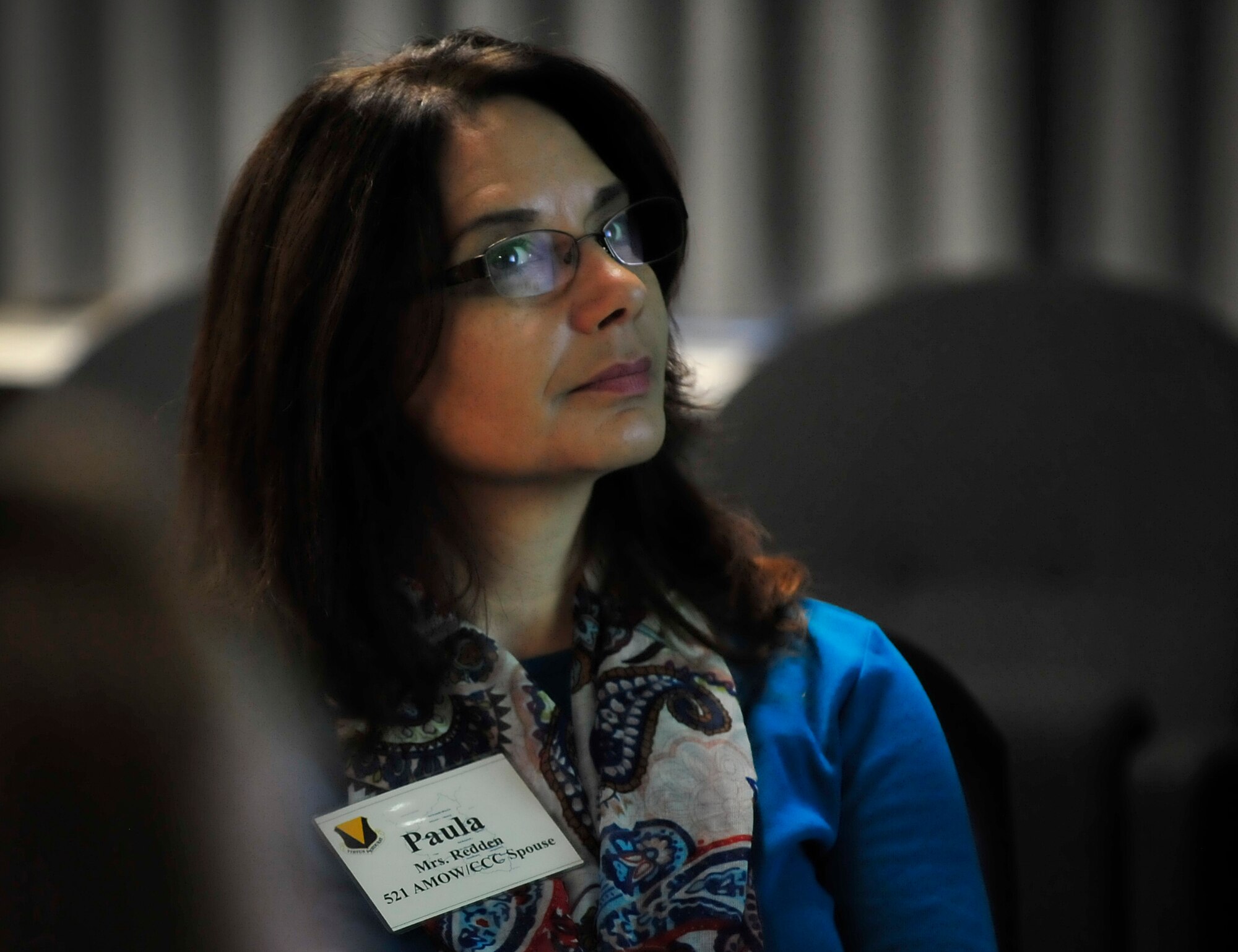Paula Redden, wife of Chief Master Sgt. Mark Redden, 521st Air Mobility Operations Wing command chief, listens to a mission brief before an immersion tour Oct. 7, 2015, at Ramstein Air Base, Germany. Spouses of Team Ramstein leaders had the opportunity to tour facilities on both Ramstein and Vogelweh Military Complex to understand what each installation has to offer. (U.S. Air Force photo/Airman 1st Class Larissa Greatwood)