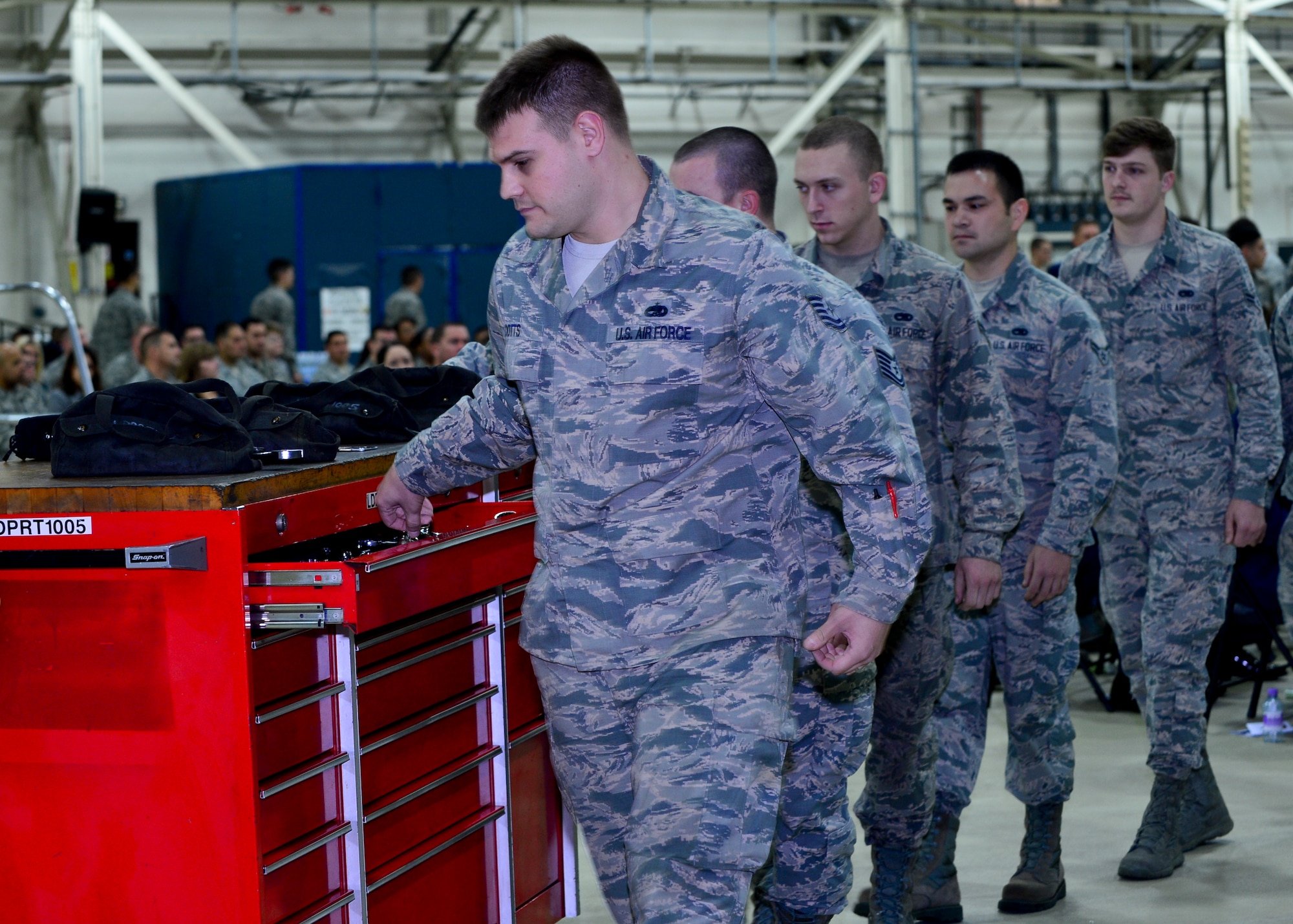 Airmen assigned to the 48th Equipment Maintenance Squadron, placed tools into a toolbox during a memorial ceremony for Airman 1st Class Darren Phillips, 48th EMS crew chief, at Royal Air Force Lakenheath, England, Oct. 11, 2015. Phillips’ toolbox was locked for the last time, allowing his team to say a final goodbye. He died from injuries sustained in a motorcycle accident on Oct. 2. (U.S. Air Force photo by Staff Sgt. Stephanie Longoria/Released)