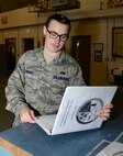U.S. Air Force Staff Sgt. Anthony Sweat, 100th Maintenance Squadron nondestructive inspection journeyman, checks paperwork in a parts log Sept. 2, 2015, on RAF Mildenhall, England. Sweat reviews this log to properly document and track inspections on aircraft and aircraft support equipment. (U.S. Air Force photo by Gina Randall/Released)