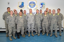 U.S. Air Force Airmen from the 727th Air Mobility Squadron pose for a photo with Maj. Gen. Frederick H. Martin, center, U.S. Air Force Expeditionary Center commander, and U.S. Air Force Maj. Sean Lewis, 727th AMS commander, during a visit Oct. 9, 2015, on RAF Mildenhall, England. Martin visited the 727th AMS along with U.S. Air Force Col. Nancy Bozzer, 521st Air Mobility Operations Wing, Ramstein Air Base, Germany, and other Air Mobility Command leadership, and coined several individuals for superior performance. (U.S. Air Force photo by Karen Abeyasekere/Released)
