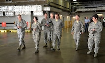 U.S. Air Force Maj. Gen. Frederick H. Martin, left, U.S. Air Force Expeditionary Center commander, talks to U.S. Air Force Tech. Sgt. Laurie Sohn, second left, 727th Air Mobility Squadron air freight NCO in charge, about the mission of the freight services facility Oct. 9, 2015, on RAF Mildenhall, England. Martin visited the 727th AMS along with U. S. Air Force Col. Nancy Bozzer, 521st Air Mobility Operations Wing commander, Ramstein Air Base, Germany, and other Air Mobility Command leadership, and coined several individuals for superior performance. (U.S. Air Force photo by Karen Abeyasekere/Released)