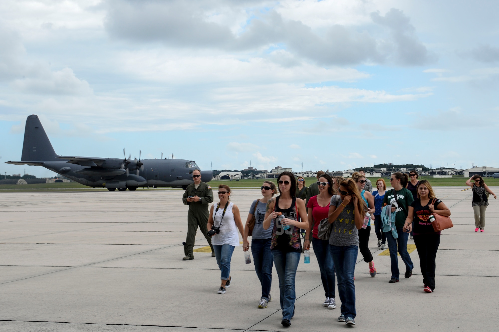 Spouses from the 353rd Special Operations Group walk away from an MC-130H Combat Talon II during a spouse orientation day Oct. 8, 2015, on Kadena Air Base, Japan. The spouses were provided an incentive flight as part of a spouse orientation day, along with a mission briefing from SOG leadership. (U.S. Air Force photo by Senior Airman John Linzmeier)