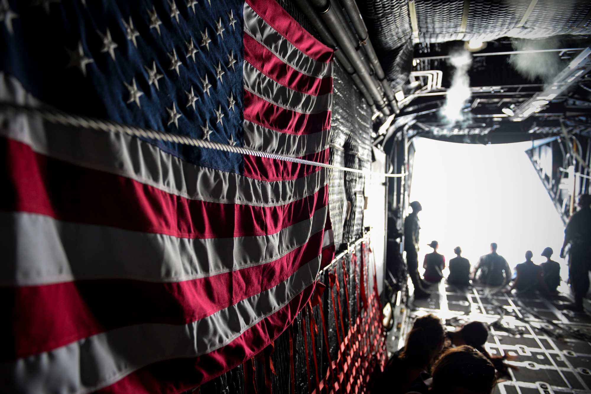 Spouses from the 353rd Special Operations Group look out the back of a MC-130H Combat Talon II during a spouse orientation flight Oct. 8, 2015, off the coast of Okinawa, Japan. Spouses of special operations Airmen often times spend and extended period of time away from their husbands and wives due to mission requirements. The orientation flight, along with various other activities, gave the spouses and opportunity to have a firsthand look at the group’s daily operations. (U.S. Air Force photo by Senior Airman John Linzmeier)