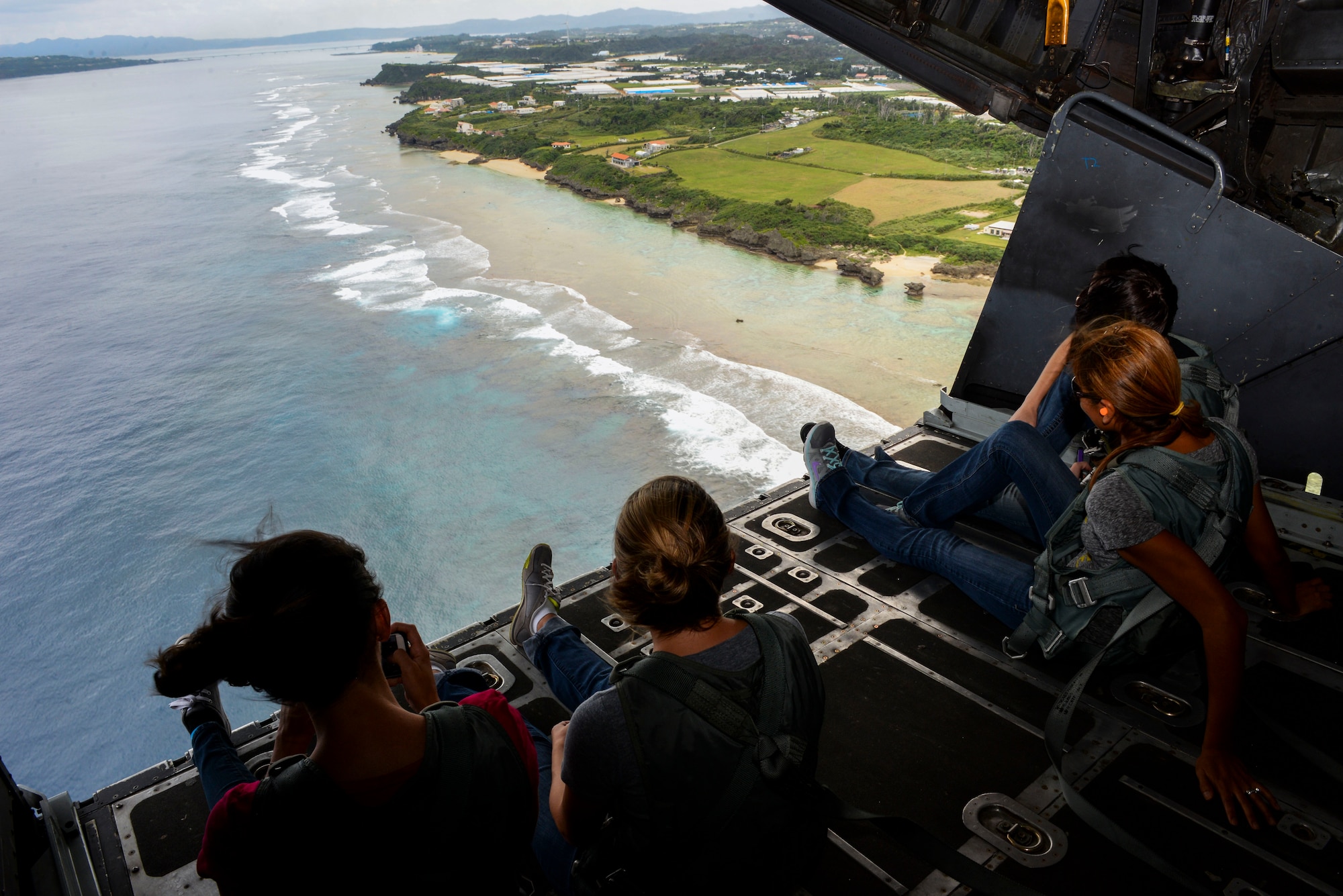 Spouses from the 353rd Special Operations Group look out the back of a MC-130H Combat Talon II during a spouse orientation flight Oct. 8, 2015, off the coast of Okinawa, Japan. Spouses of special operations Airmen often times spend and extended period of time away from their husbands and wives due to mission requirements. The orientation flight, along with various other activities, gave the spouses and opportunity to have a firsthand look at the group’s daily operations. (U.S. Air Force photo by Senior Airman John Linzmeier)
