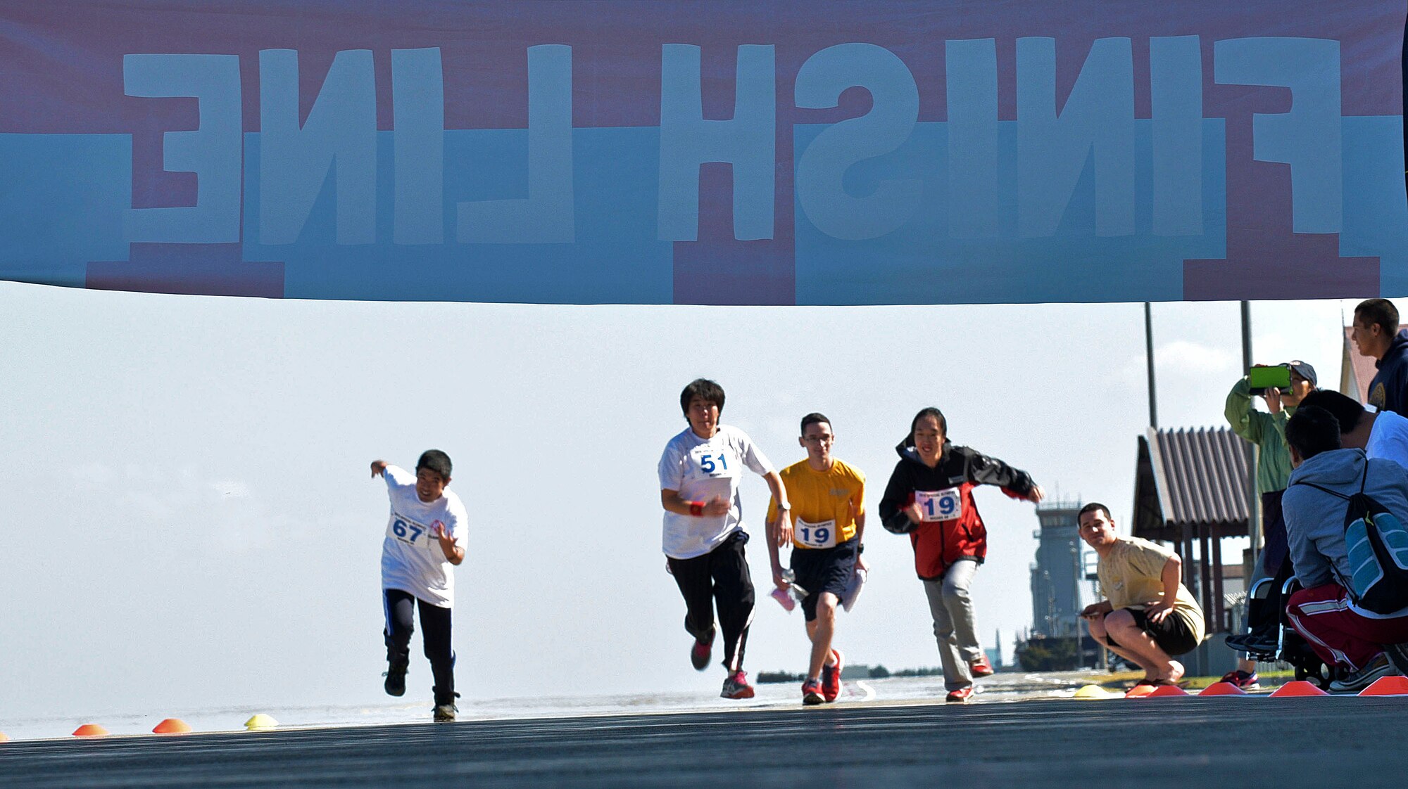 A group of Olympic participants, alongside a U.S. Navy service member, compete in a race during the 29th Annual Special Olympics at Misawa Air Base, Japan, Oct. 10, 2015. More than 70 athletes from across the Aomori prefecture were invited to the base to take part in the Special Olympics. (U.S. Air Force photo by Senior Airman Jose L. Hernandez-Domitilo/Released)
