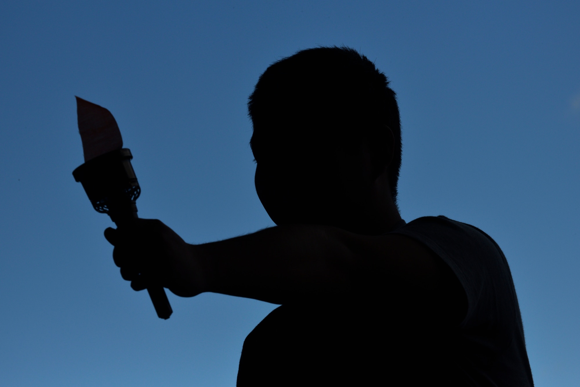 A competitor carries a ceremonial torch as part of a walkthrough signifying the beginning of the 29th Annual Special Olympics at Misawa Air Base, Japan, Oct. 10, 2015. All athletes were greeted with resounding cheers as they made their way to the event stage. (U.S. Air Force photo by Senior Airman Jose L. Hernandez-Domitilo/Released)