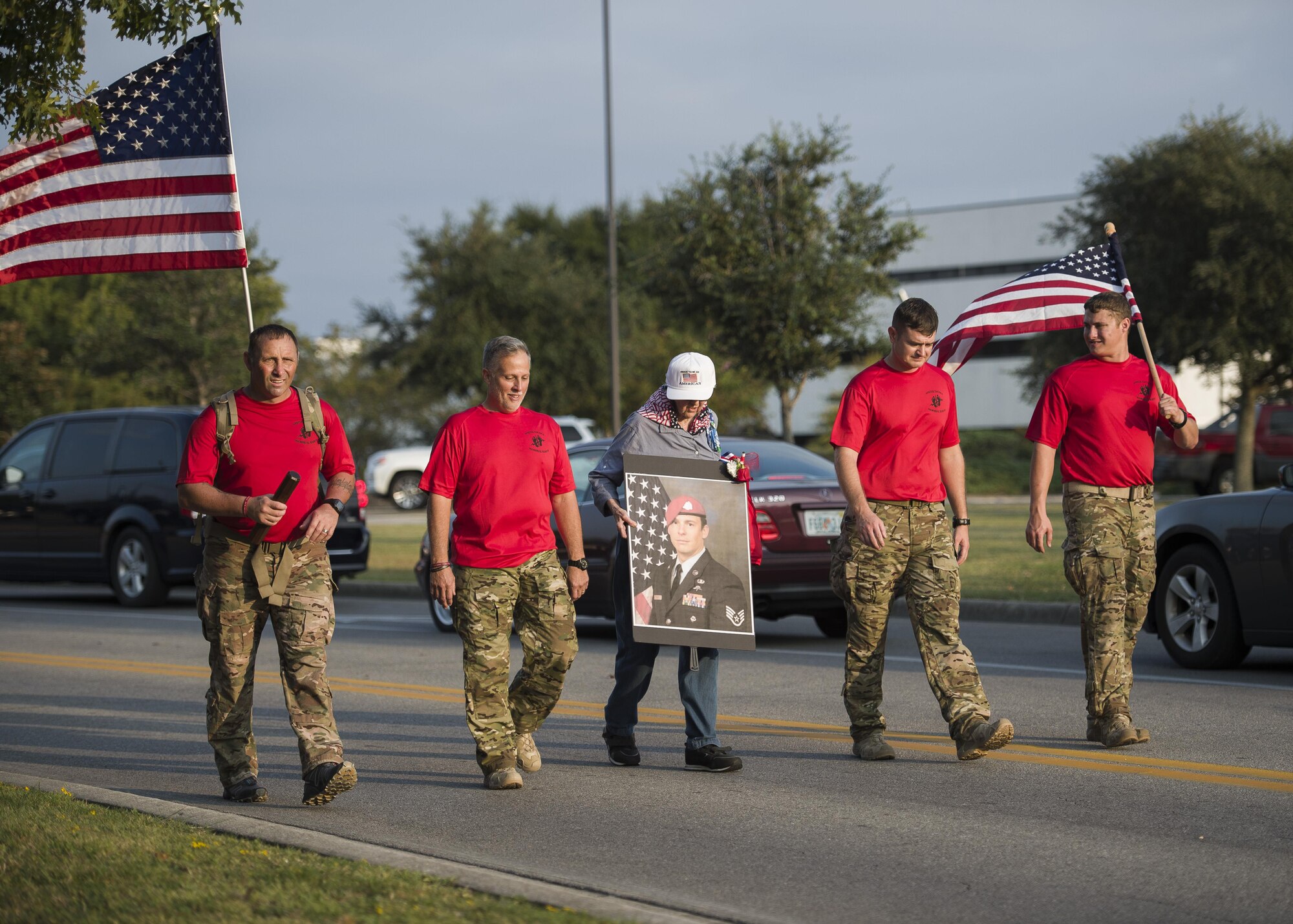 A grandmother of one of the fallen Special Tactics Airmen carries a photo in honor of her loved one to a Baton Ceremony on Hurlburt Field, Fla., Oct. 13, 2015. The team of 20 Special Tactics Airmen started at 2 a.m. on Oct. 4, from Joint Base San Antonio-Lackland, Texas, and marched 812 miles through five states to meet with the gold star families and end the memorial march with a ceremony on Hurlburt Field. Each two-man team walked approximately 90 miles during the 10-day trek while carrying a 50-pound ruck sack and a commemorative baton engraved with a fallen Special Tactics Airman's name. The memorial march is only held when a Special Tactics operator is killed in action that year, but honors all 19 Special Tactics pararescuemen and combat controllers who have been killed in action since 2001. (U.S. Air Force photo by Airman Kai White/Released)
