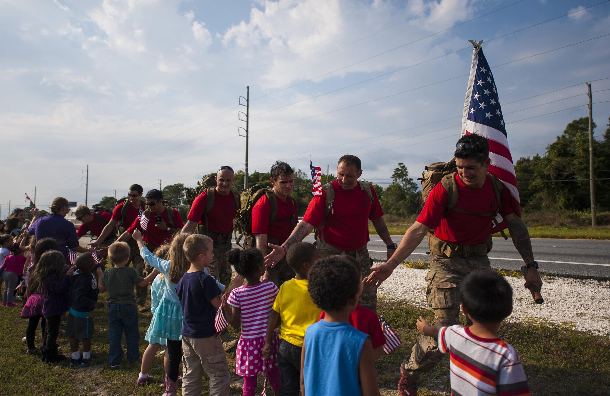 Special Tactics Airmen greet a local elementary school class in Fort Walton Beach, Fla., Oct. 13, 2015. The team of 20 Special Tactics Airmen started at 2 a.m. on Oct. 4, from Joint Base San Antonio-Lackland, Texas, and marched 812 miles through five states to meet with the gold star families and end the memorial march with a ceremony on Hurlburt Field. Each two-man team walked approximately 90 miles during the 10-day trek while carrying a 50-pound ruck sack and a commemorative baton engraved with a fallen Special Tactics Airman's name. The memorial march is only held when a Special Tactics operator is killed in action that year, but honors all 19 Special Tactics pararescuemen and combat controllers who have been killed in action since 2001. (U.S. Air Force photo by Airman Kai White/Released)