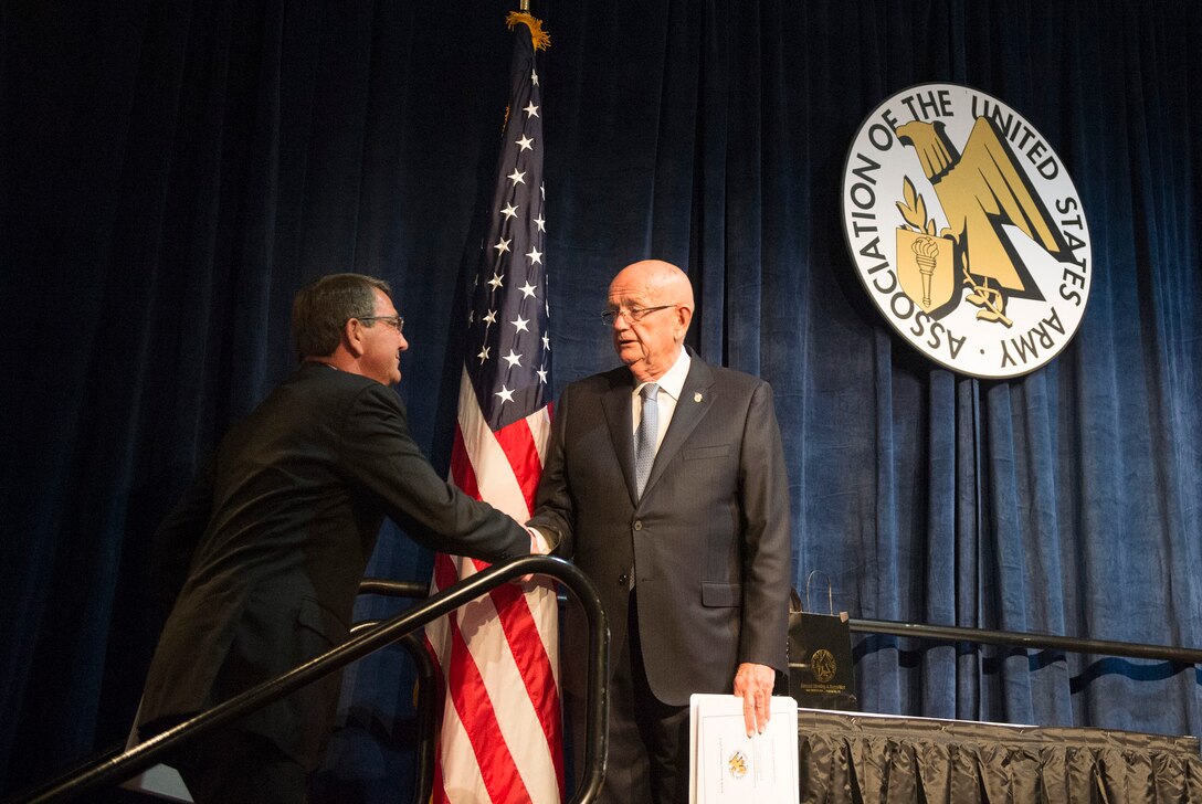 Retired Army Gen. Gordon R. Sullivan, president and chief executive officer of the Association of the U.S. Army, welcomes Defense Secretary Ash Carter on stage during the AUSA sustaining member luncheon in Washington, D.C., Oct. 14, 2015. DoD photo by Air Force Senior Master Sgt. Adrian Cadiz