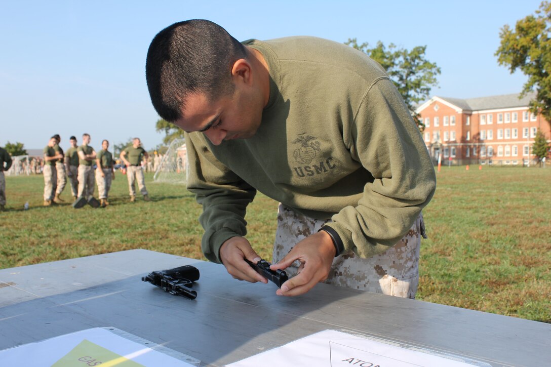 Warrant Officer Danny Lerma, Installation Personnel Administration Center, reassembles an M9 pistol as part of the battle skills relay event at the Combined Federal Campaign kick off field meet. The meet was held aboard Marine Corps Base Quantico.