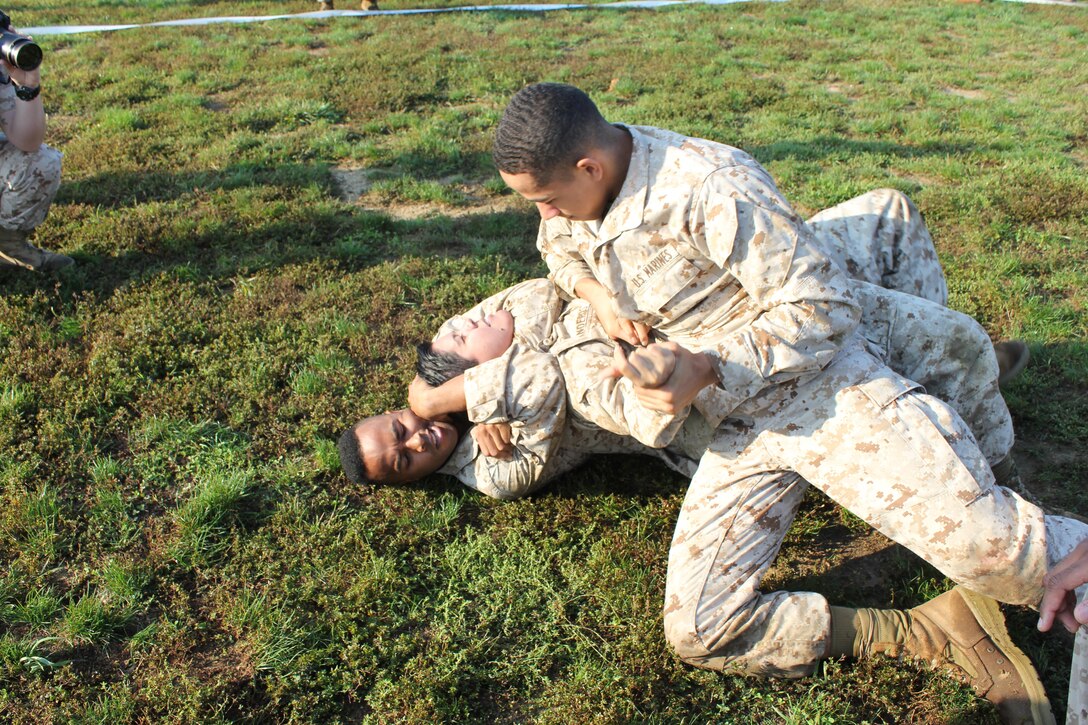 Lance Cpl. Vanessa Landeros, Manpower Managemenet Officer Assignment, is put in a choke hold during the Spartan Games at the CFC kick-off field meet.