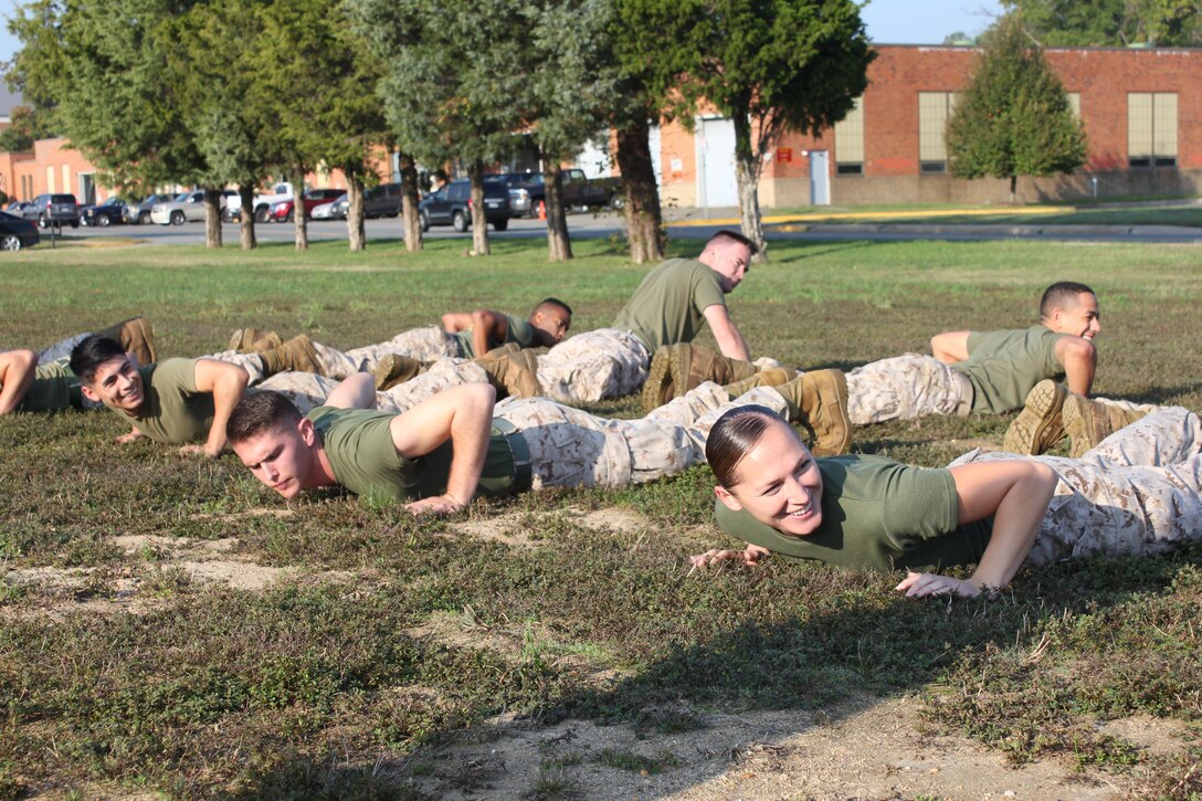 Staff Sgt. Sarah Hickory and her squad from Combat Camera wait for the tug-of-war challenge to begin at the 2015 CFC kick-off field meet.